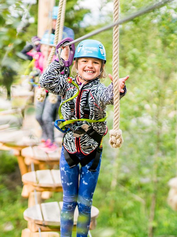 A girl on a family holiday in Trysil, Eastern Norway, in the climbing park Høyt & Lavt