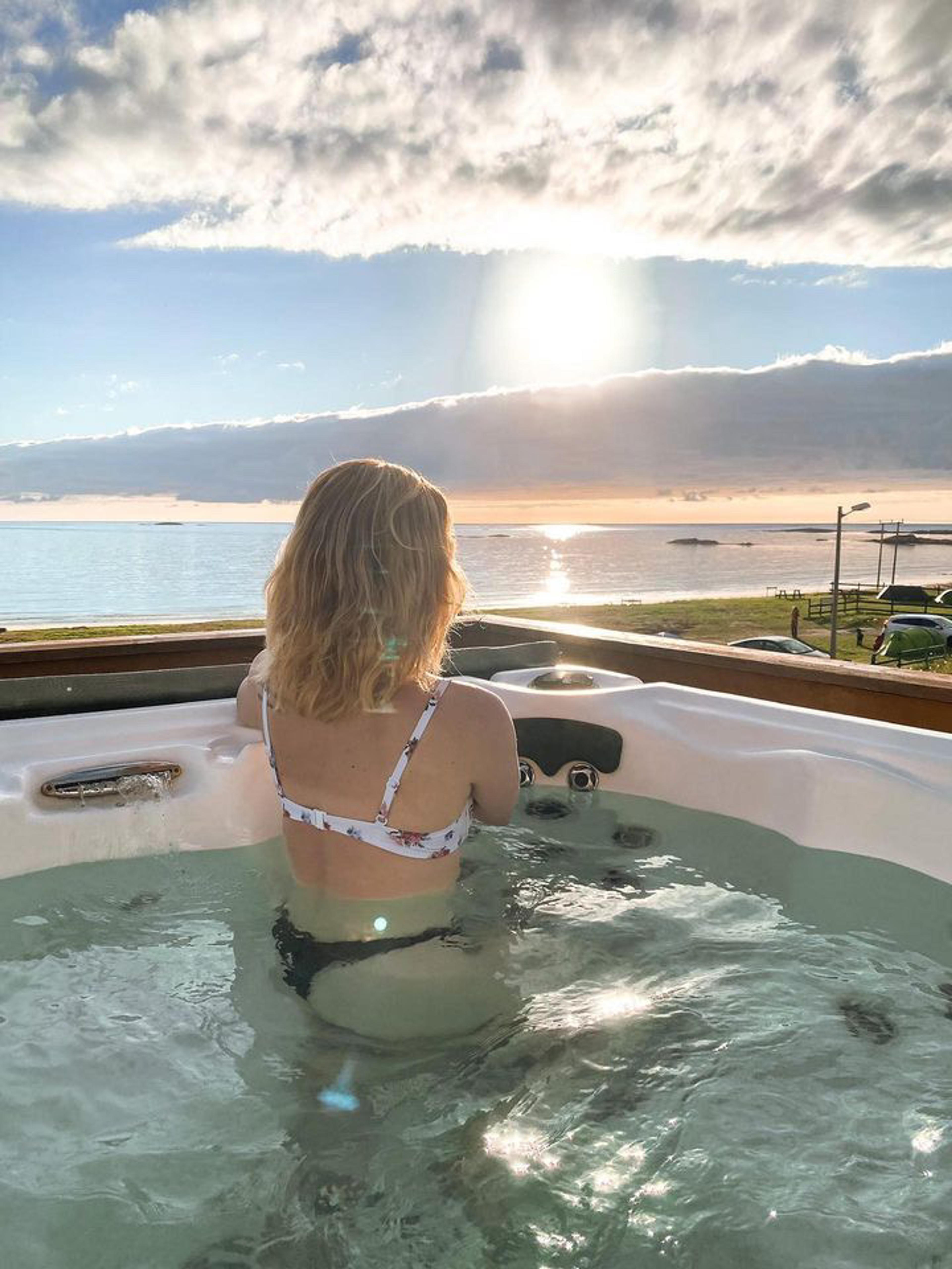 A woman in the hot pools at Stave, Andøya