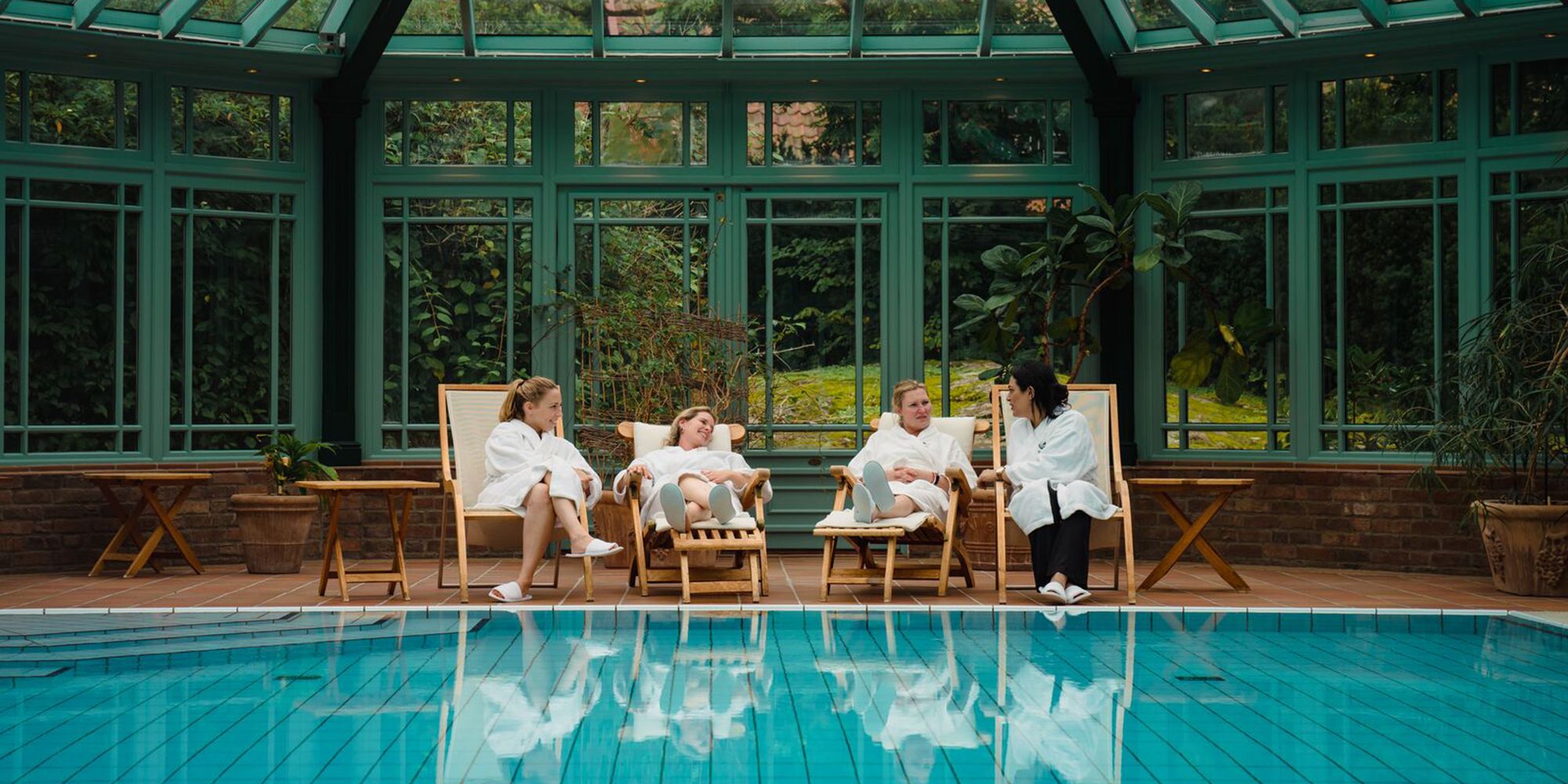 Four women relaxing by the indoor pool at Engø gård at Tjøme, Eastern Norway