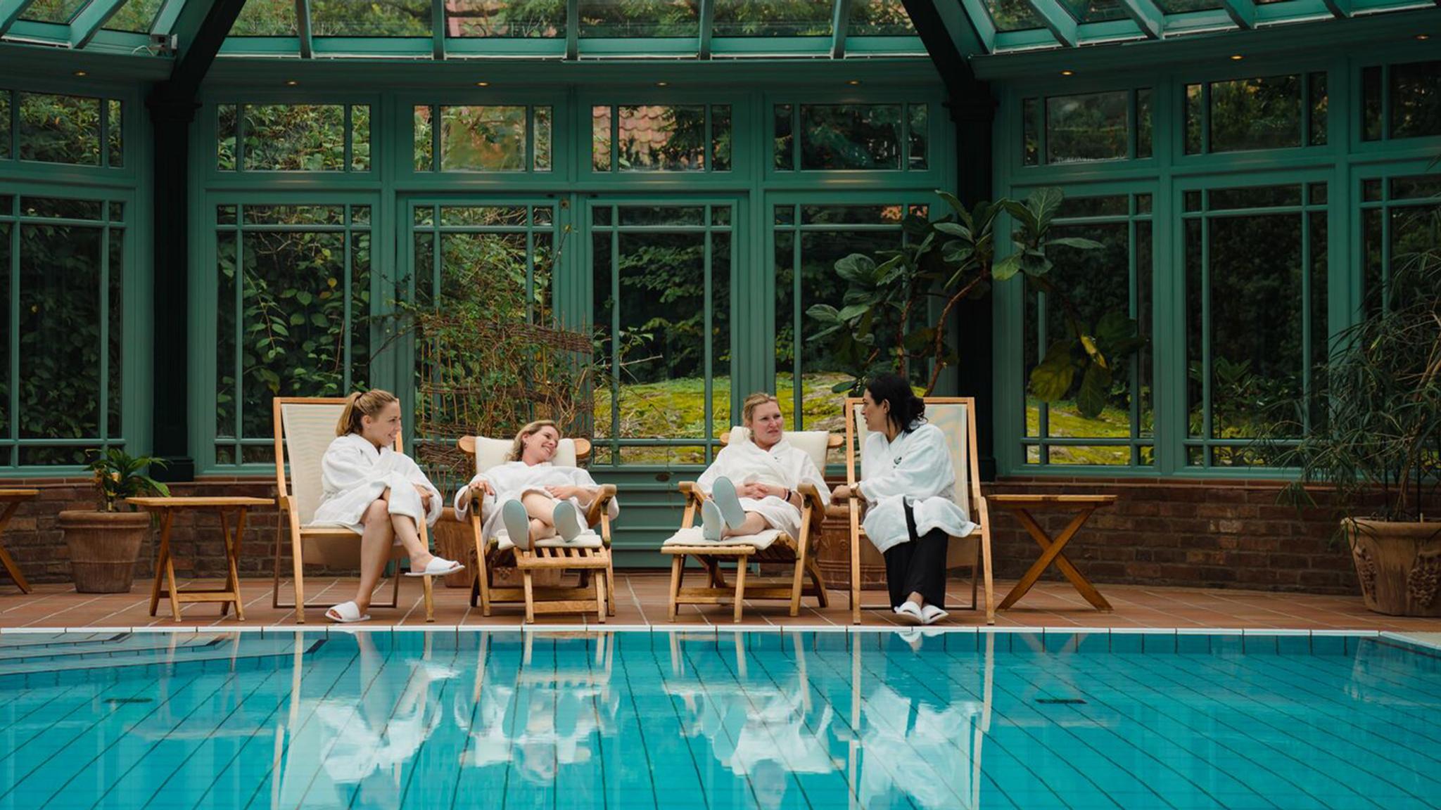 Four women relaxing by the indoor pool at Engø gård at Tjøme, Eastern Norway