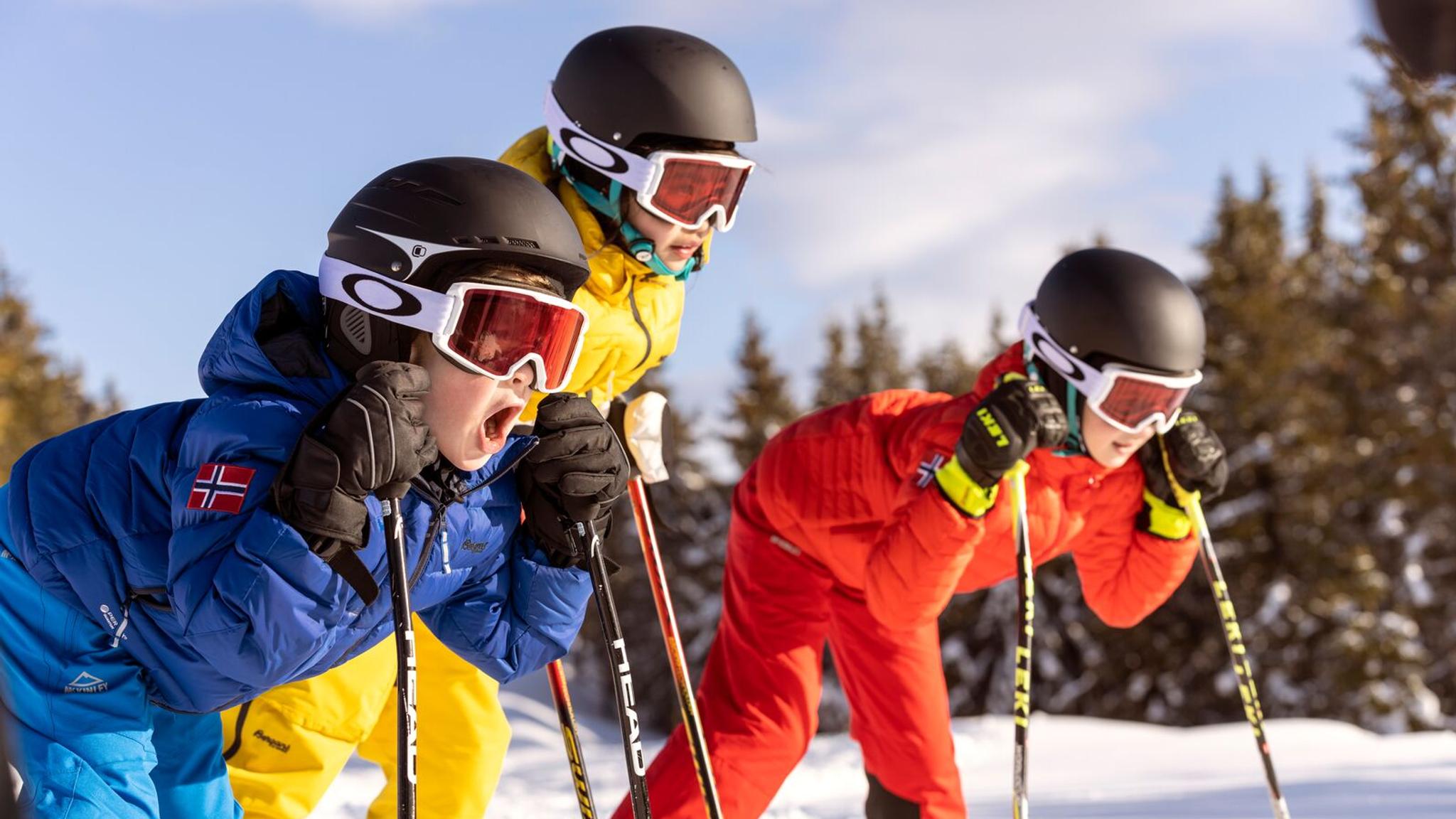 Three alpine skiing kids ready for action in the slopes of Hafjell