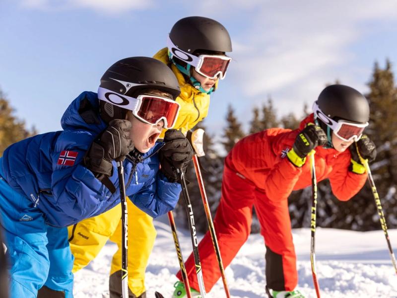 Three alpine skiing kids ready for action in the slopes of Hafjell
