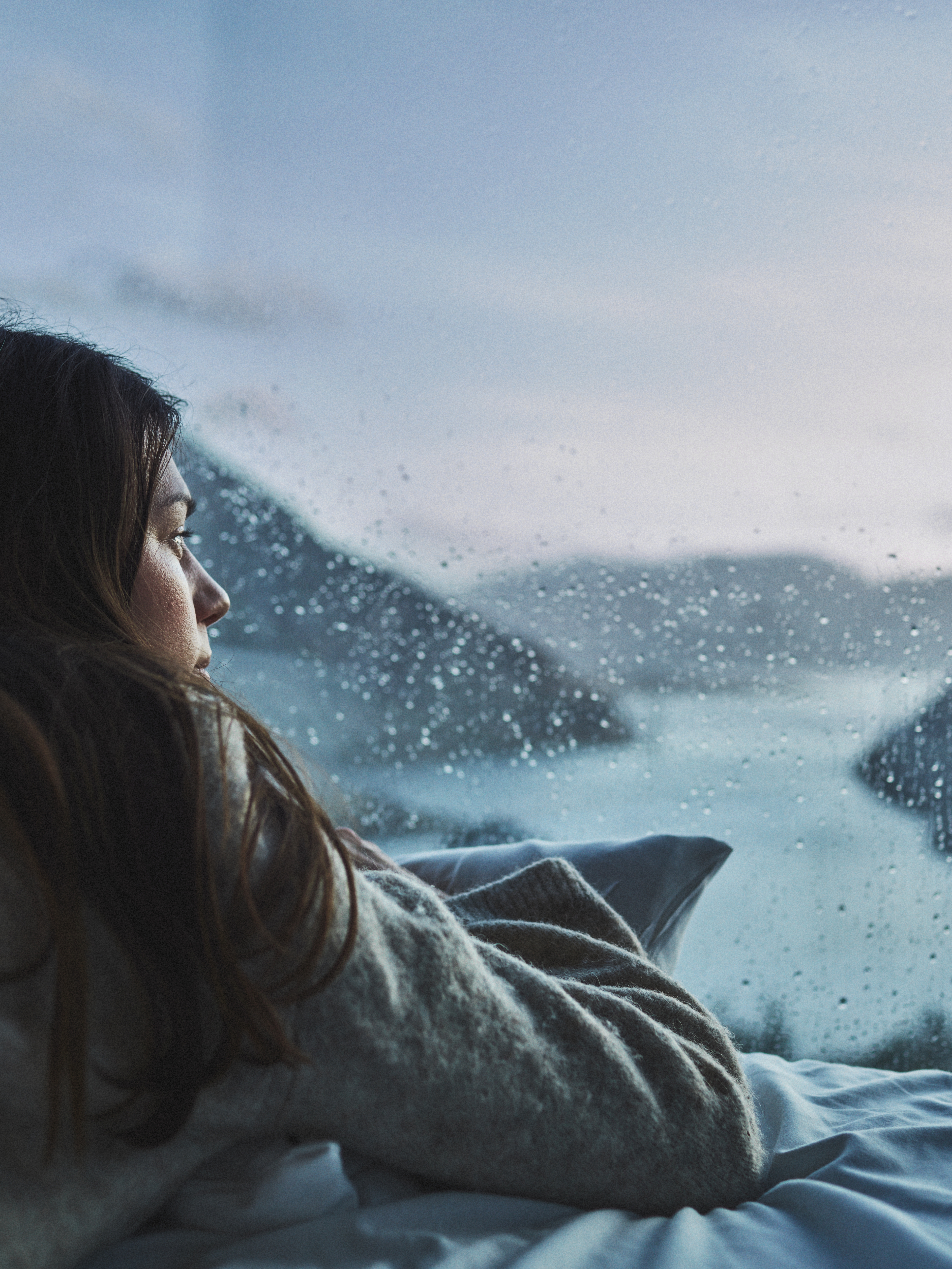 Woman in bed looking at the view over Lysefjorden from the Bolder in Rogaland, Fjord Norway