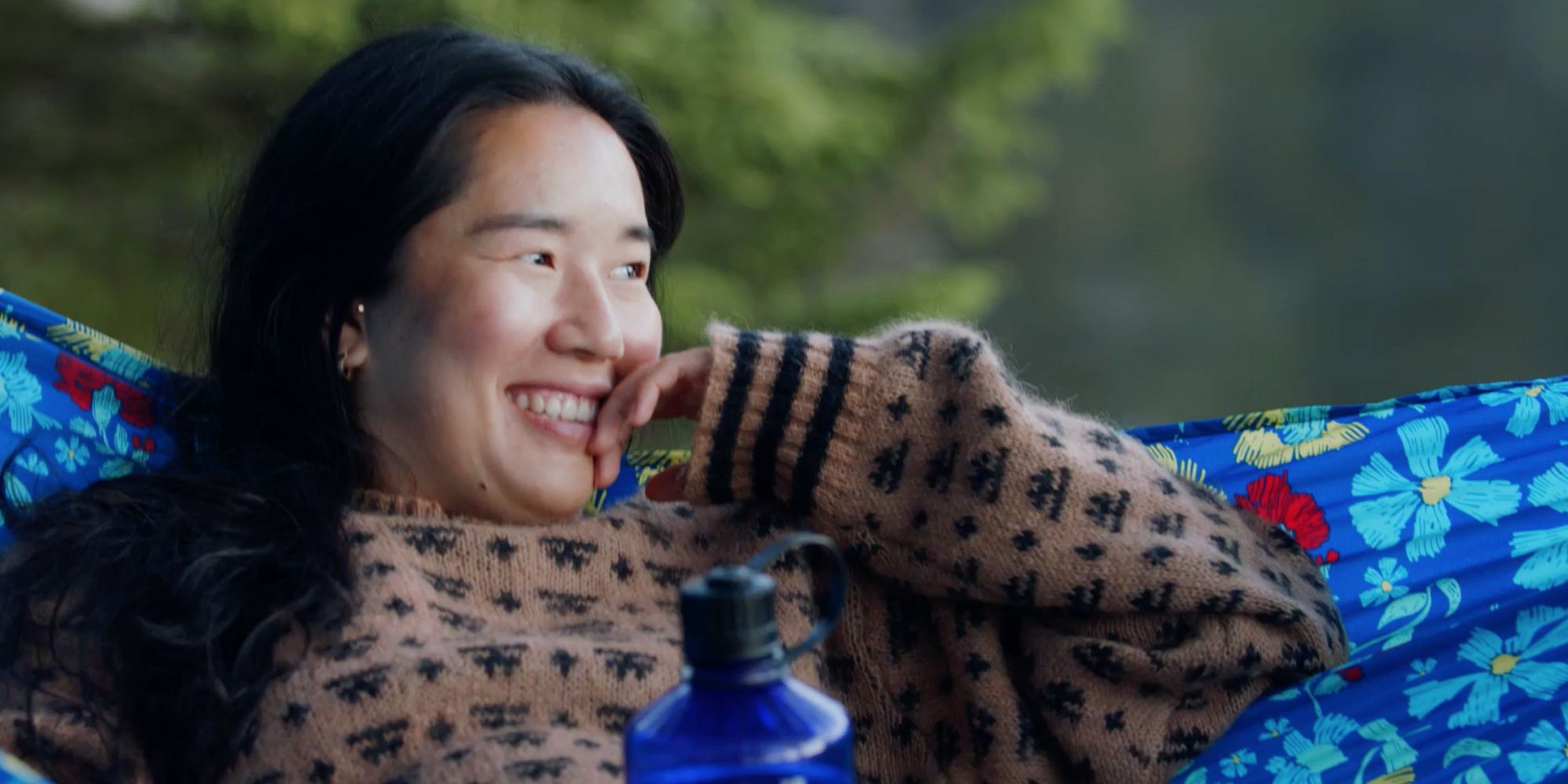 Girl resting in hammock, enjoying nature