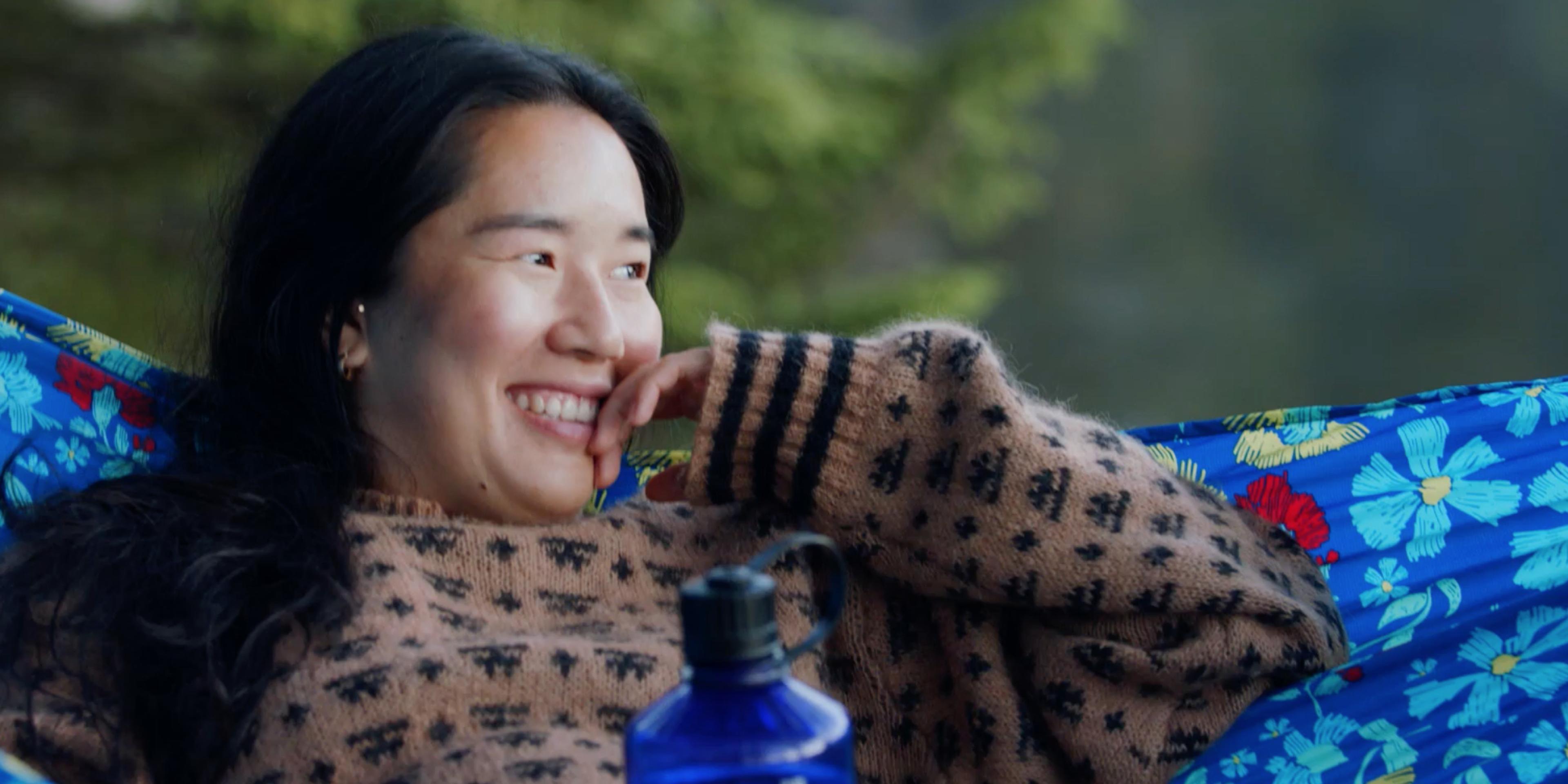 Girl resting in hammock, enjoying nature