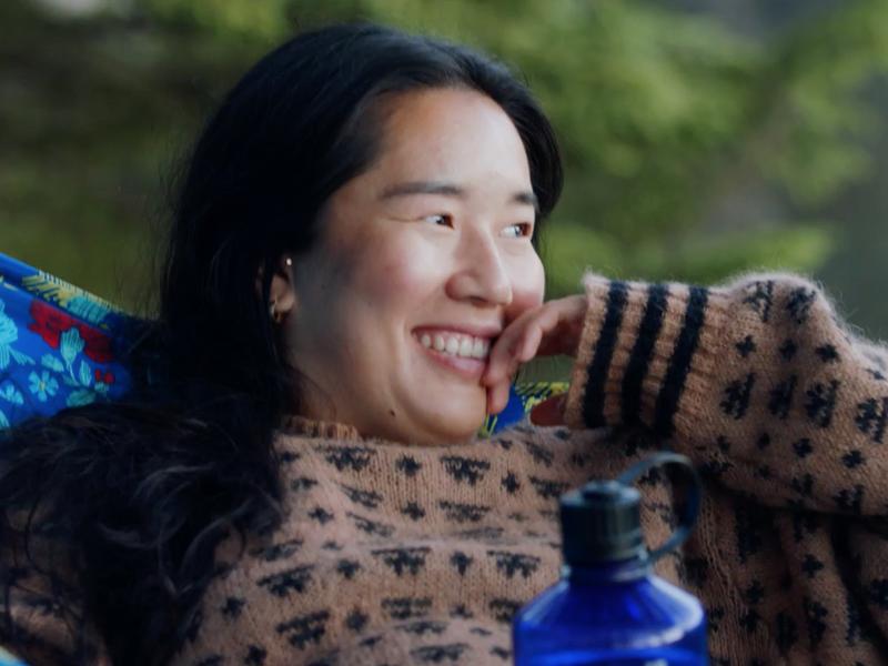 Girl resting in hammock, enjoying nature