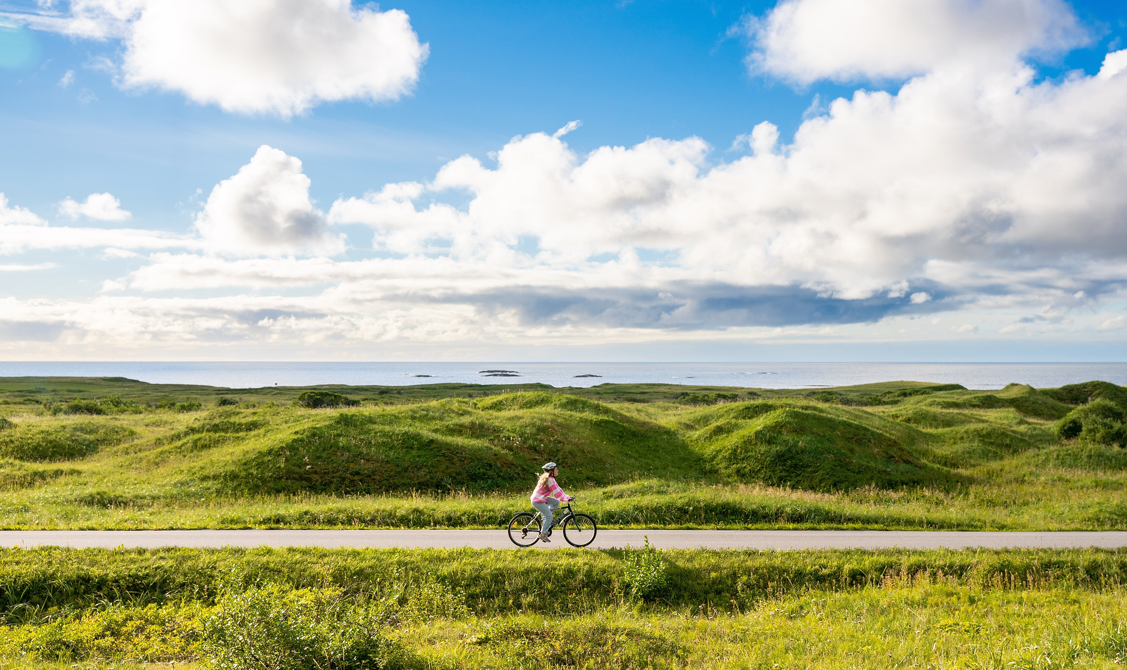Woman biking the Norwegian Scenic Route at Andøya