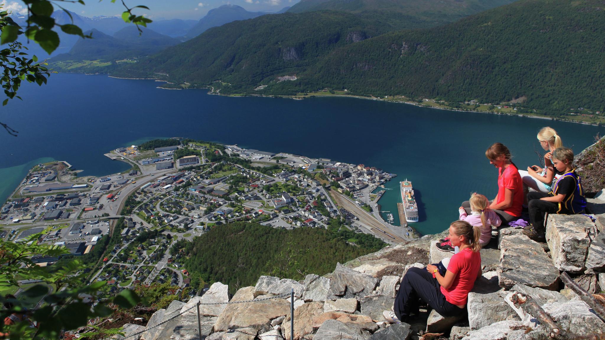 A group og people enjoying the view of Åndalsnes from the top of the Romsdalstrappa in Northwest, Fjord Norway.