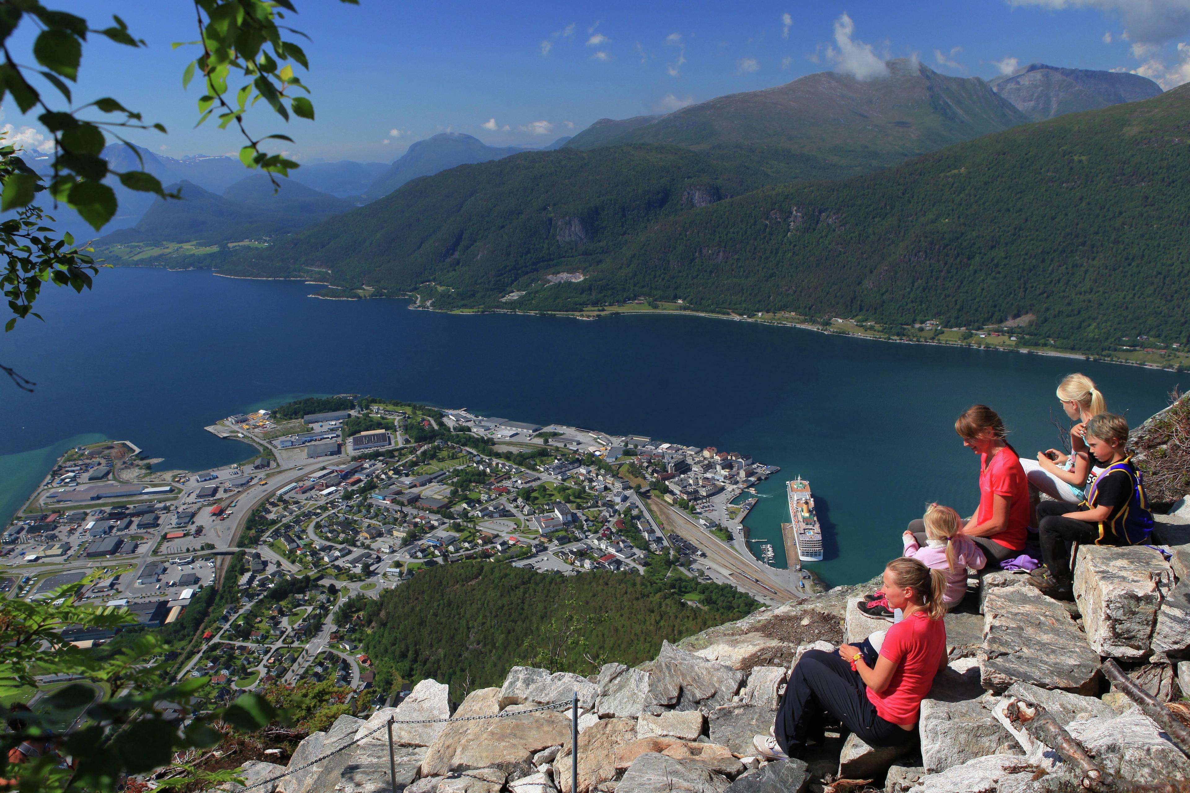 A group og people enjoying the view of Åndalsnes from the top of the Romsdalstrappa in Northwest, Fjord Norway.