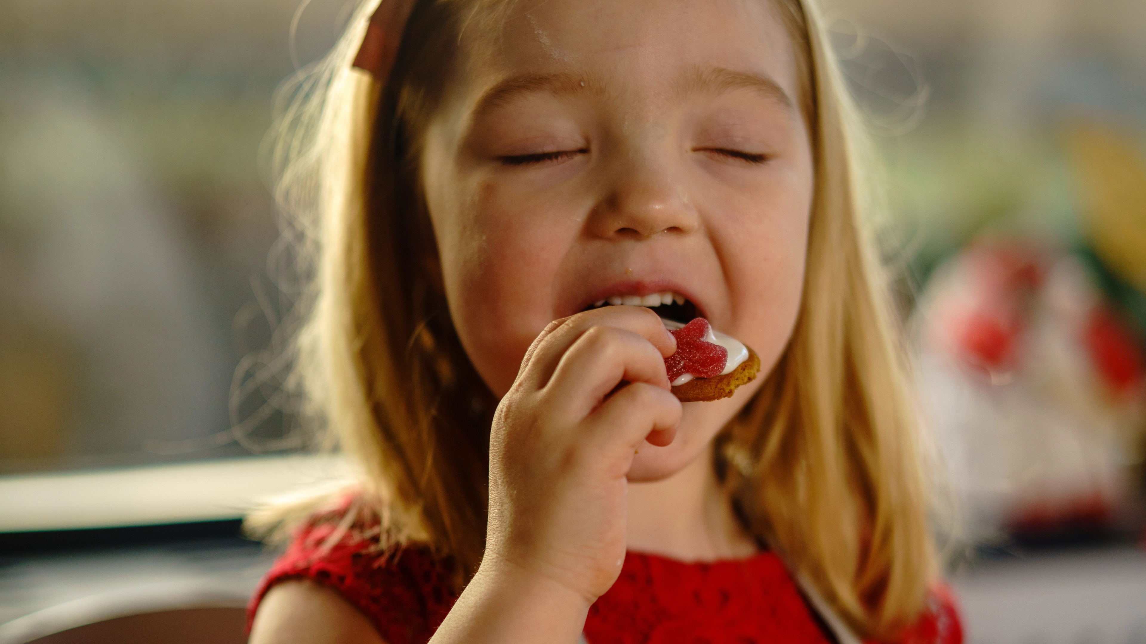 Andrea (5) takes a bite of a christmas cookie