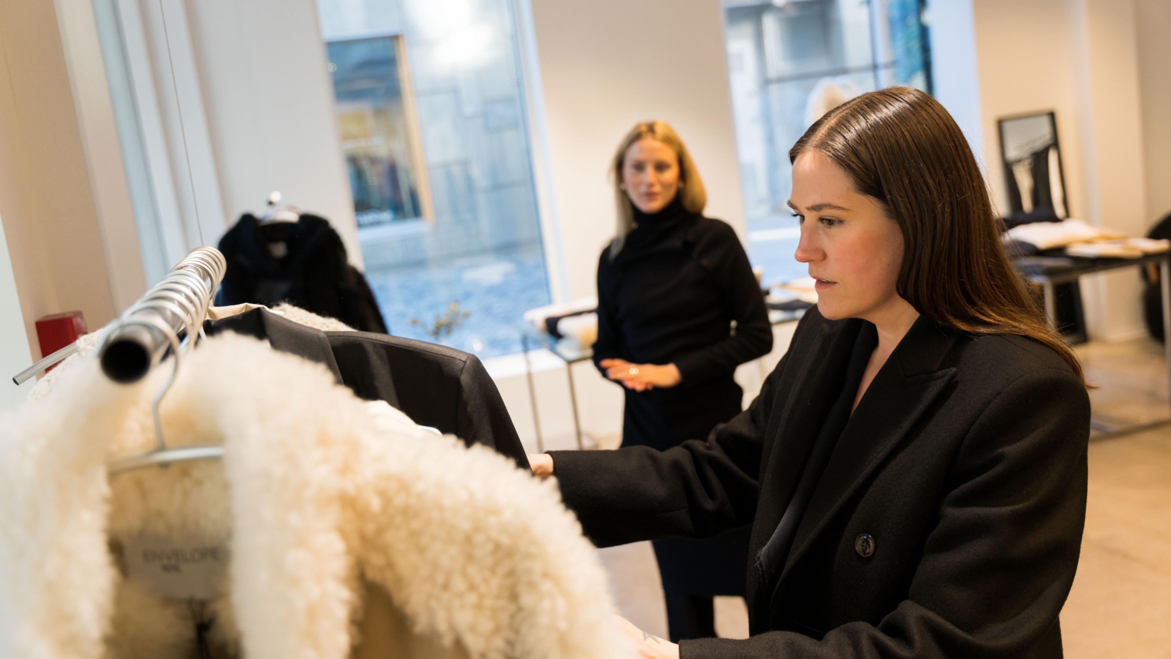 Ida Elise Eide Einarsdottir looking at clothes in the Envelope 1976 store, in Oslobukta