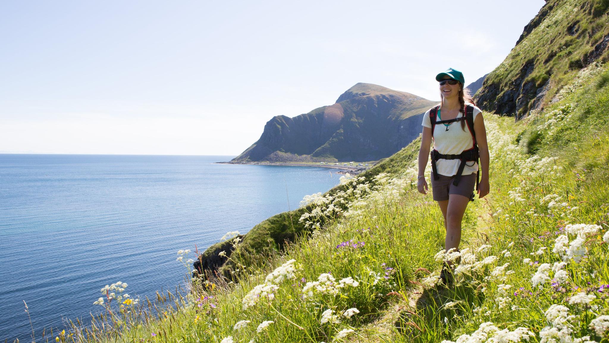 Woman hiking in the summer in Lofoten in Northern Norway