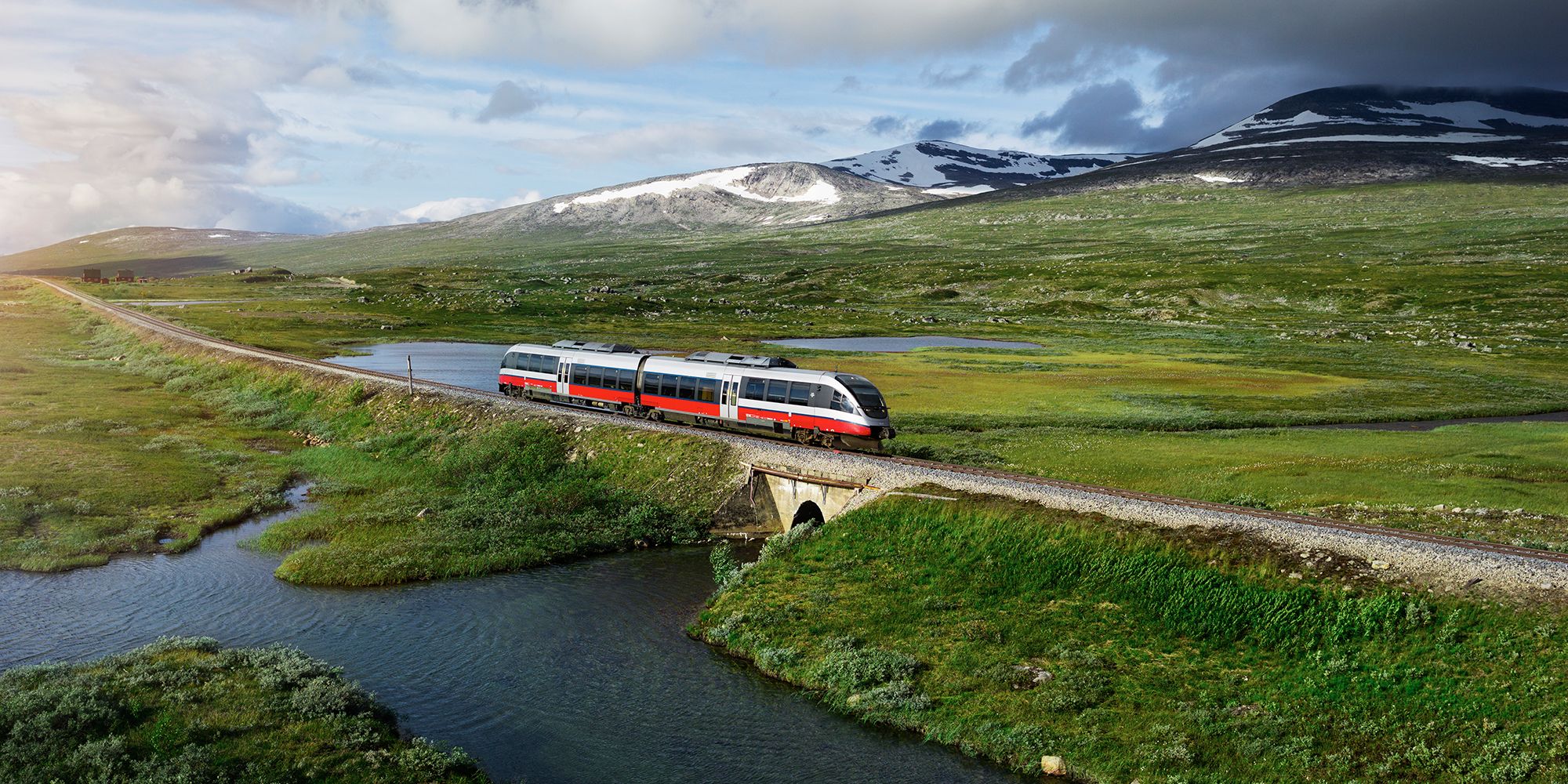 A train passing by a lake in Saltfjellet mountain area in Nordland