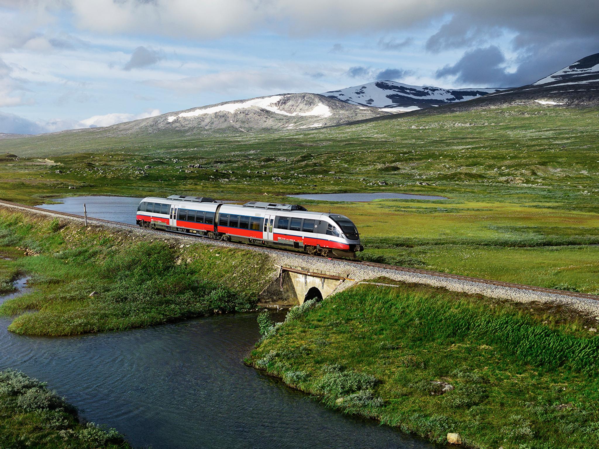 A train passing by a lake in Saltfjellet mountain area in Nordland