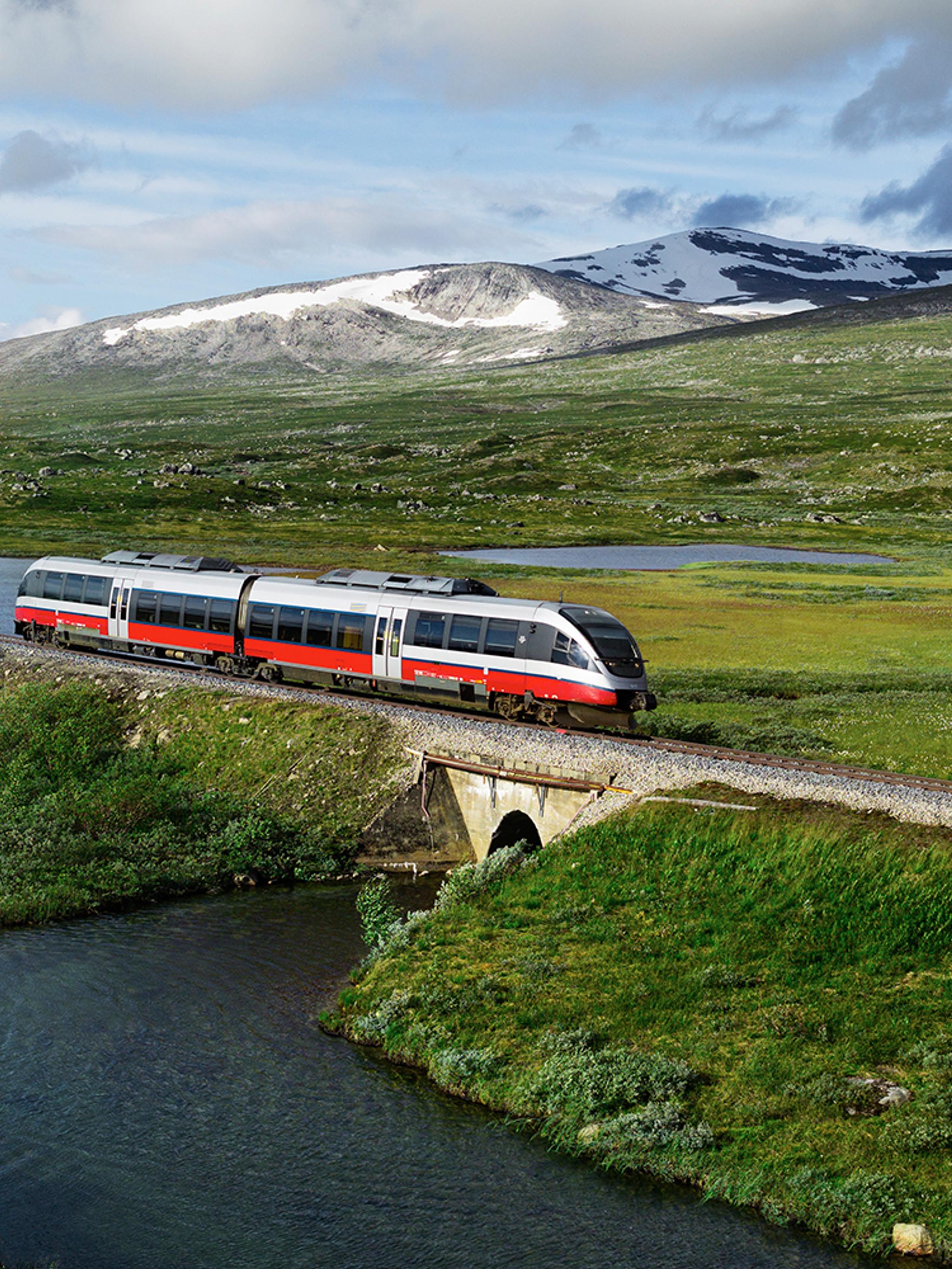 A train passing by a lake in Saltfjellet mountain area in Nordland