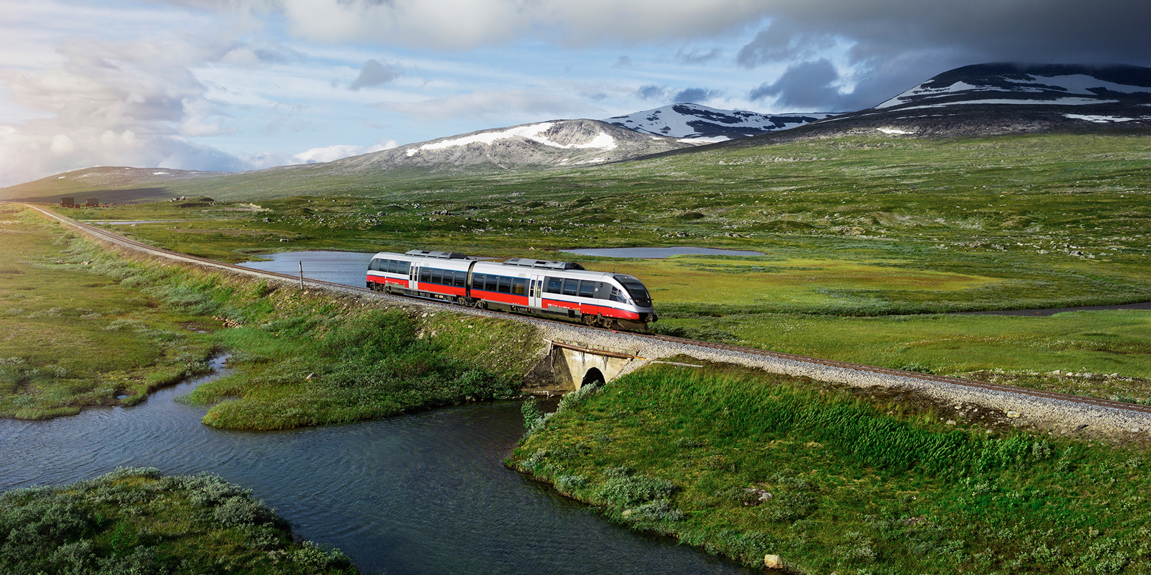 A train passing by a lake in Saltfjellet mountain area in Nordland
