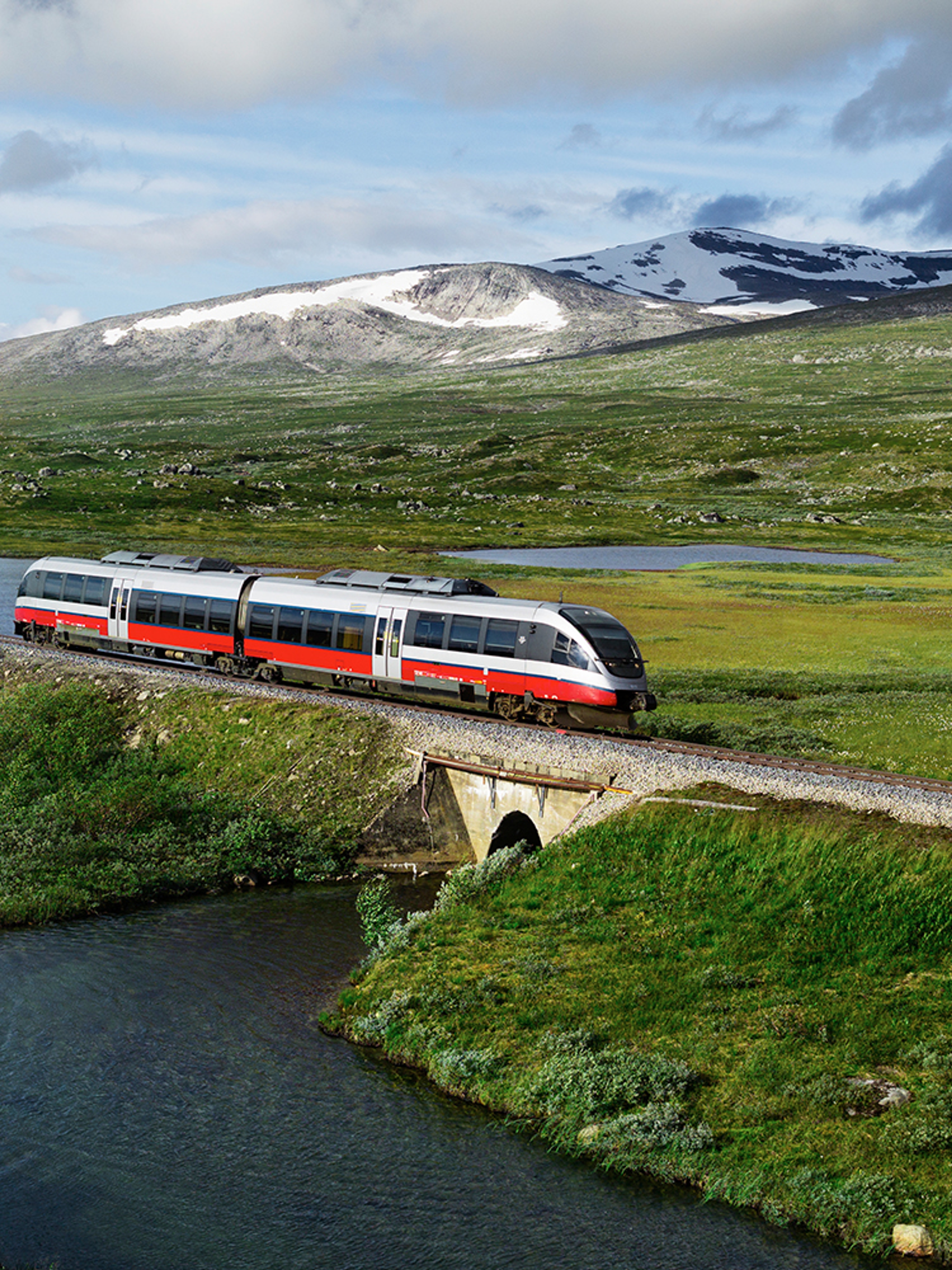 A train passing by a lake in Saltfjellet mountain area in Nordland