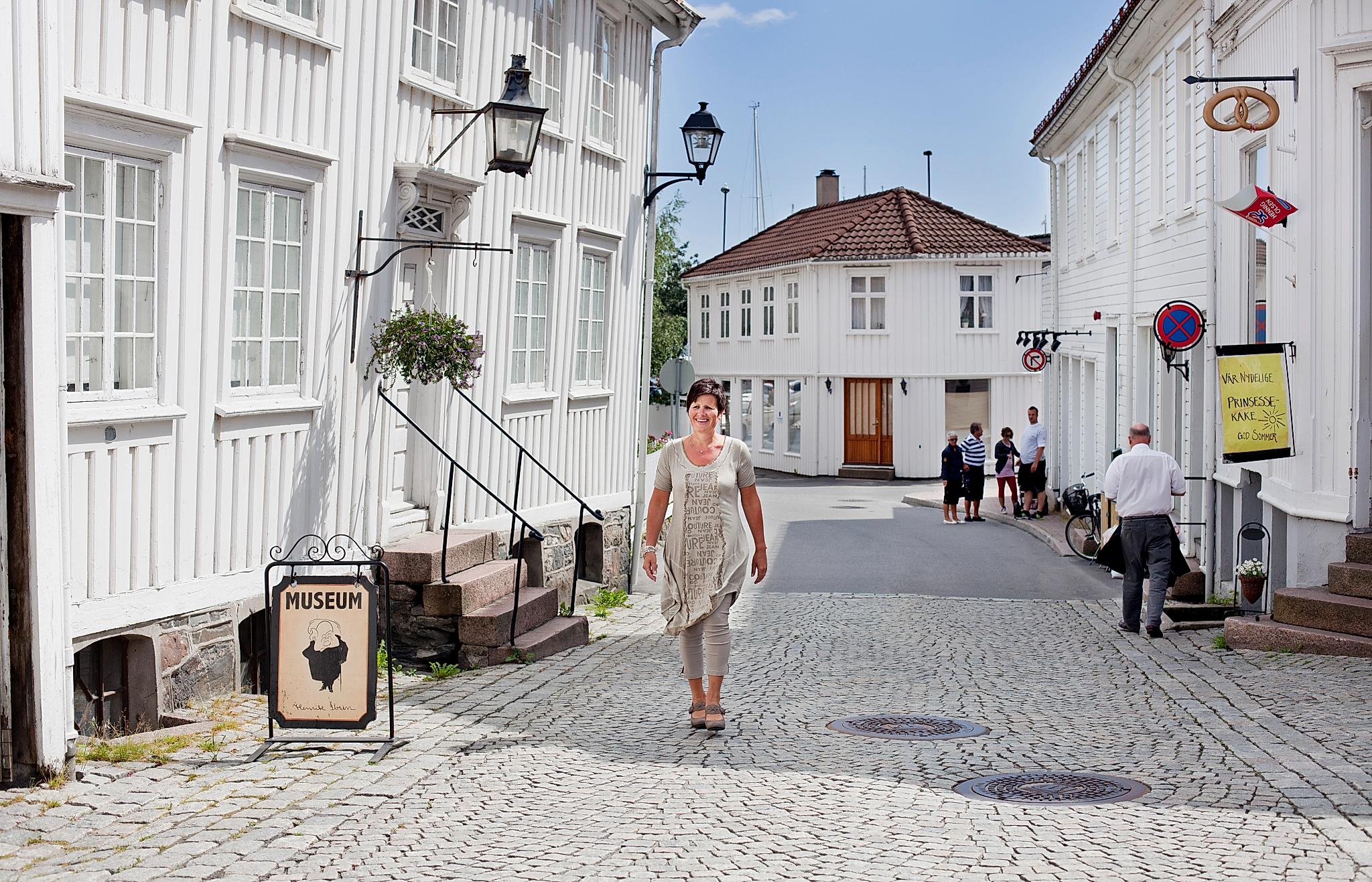 A woman walking past the Ibsen museum in Grimstad in Southern Norway.