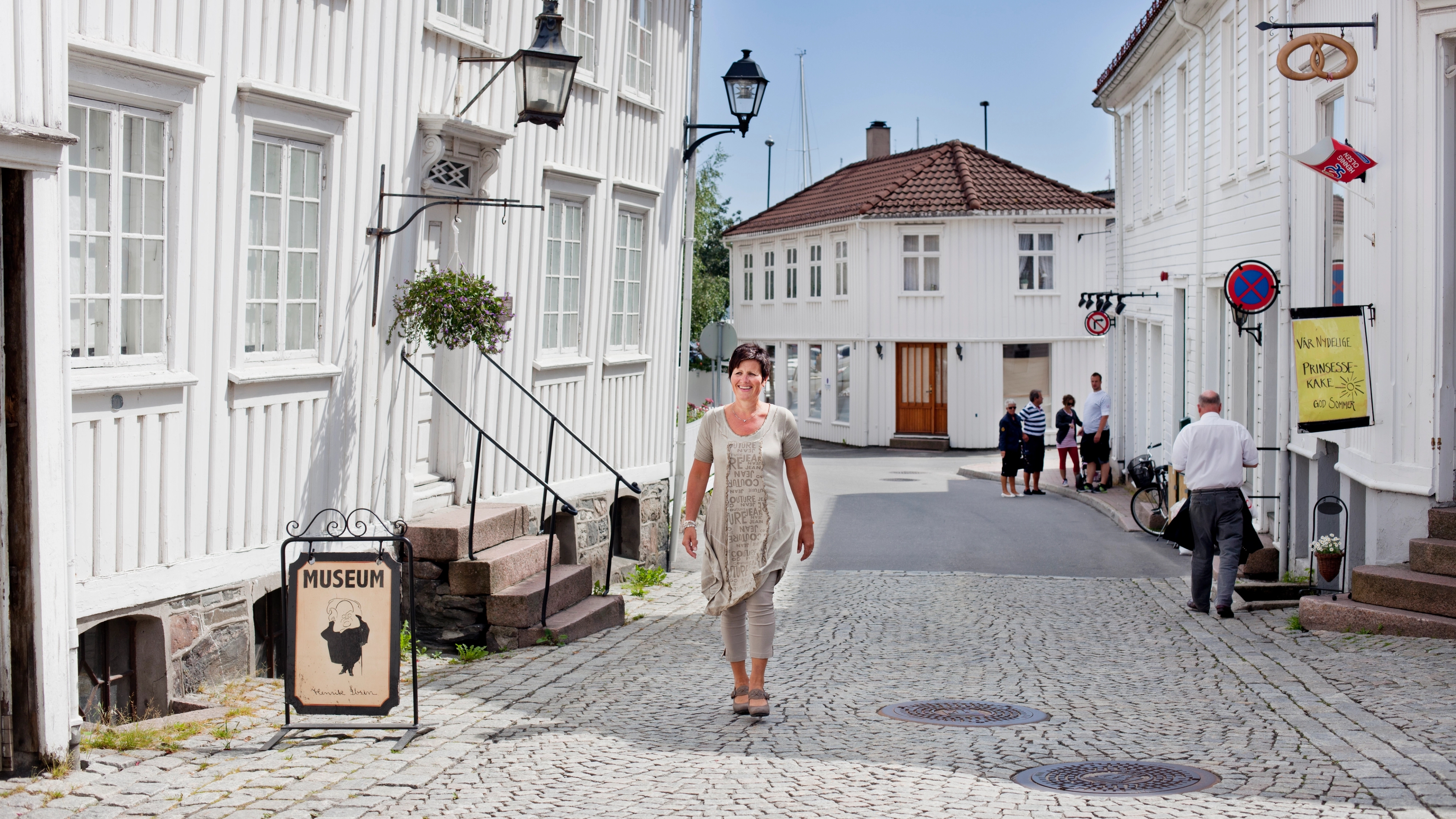 A woman walking past the Ibsen museum in Grimstad in Southern Norway.