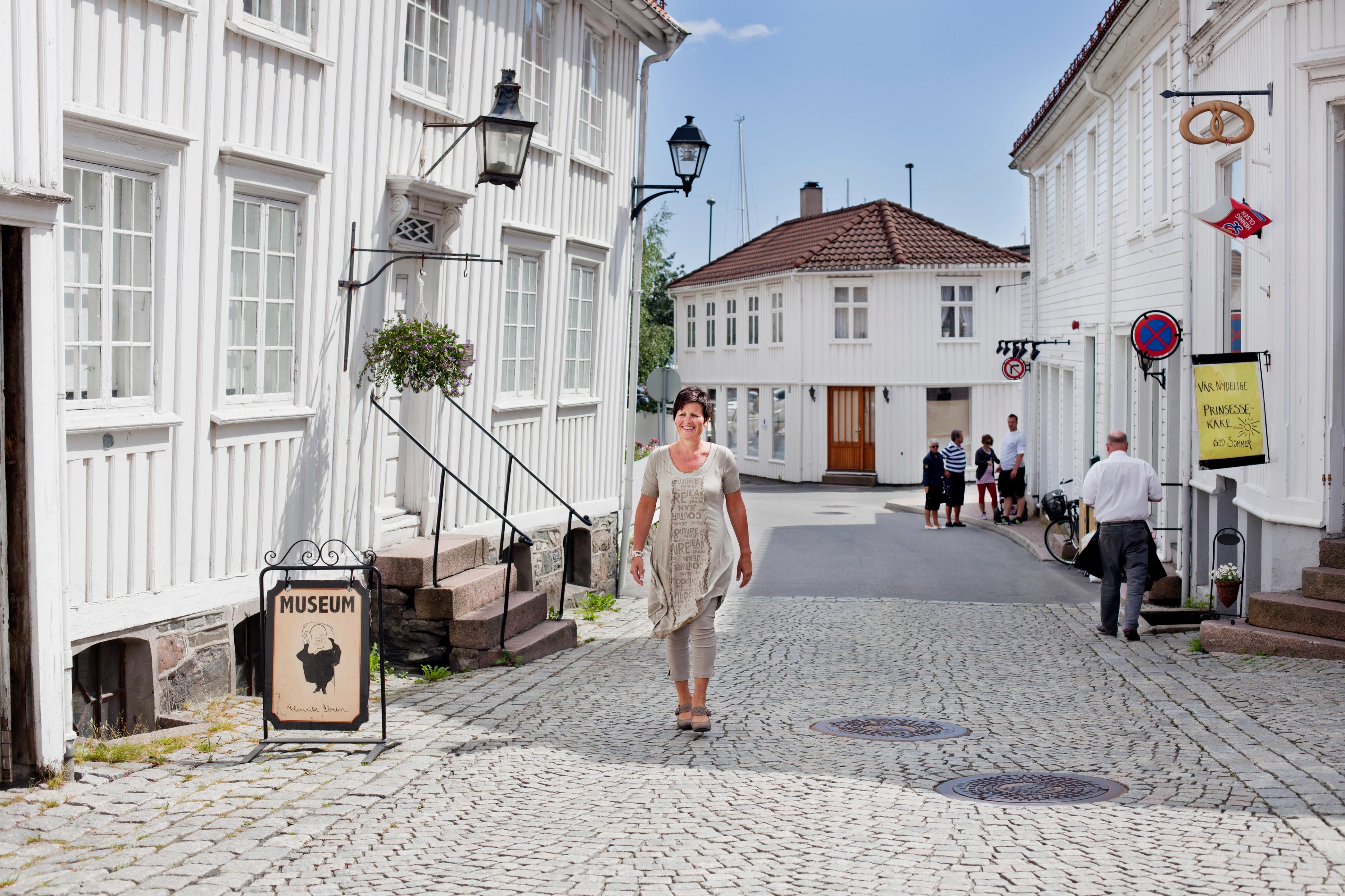 A woman walking past the Ibsen museum in Grimstad in Southern Norway.
