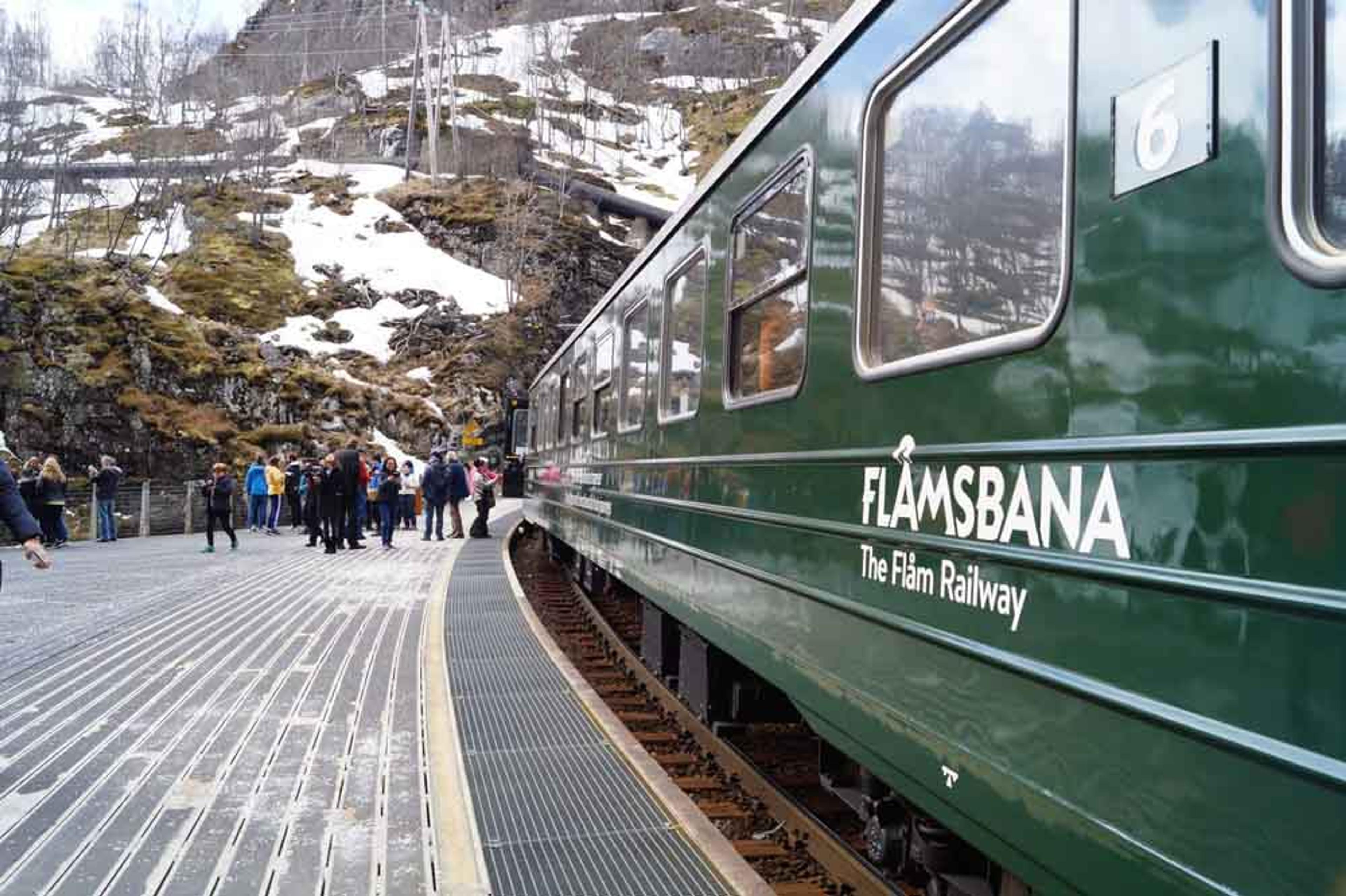 The Flåmsbana railway train standing at a train platform.