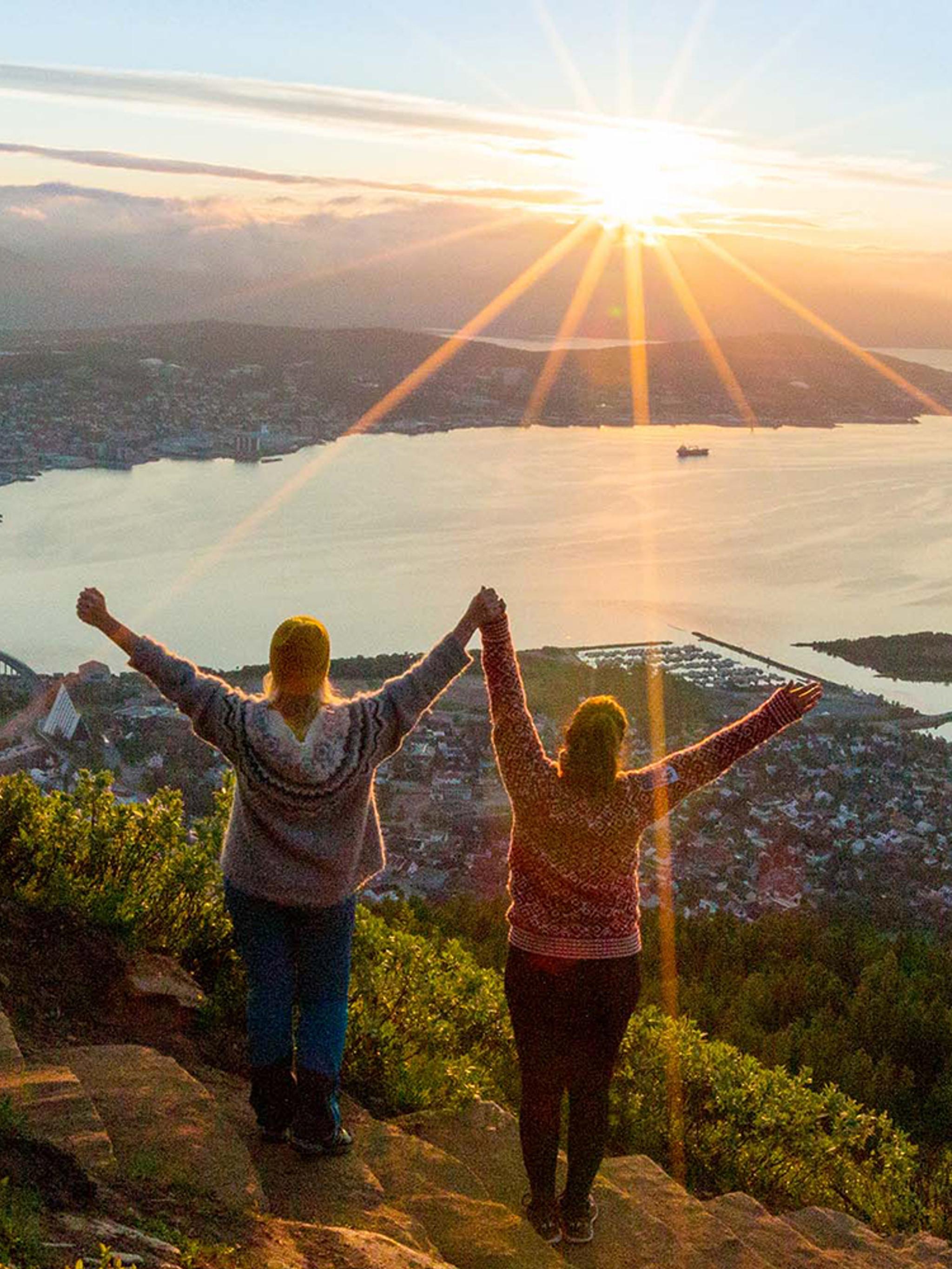 Two women are hiking up the Sherpa staircase to Mount Storsteinen in Tromsø, Northern Norway