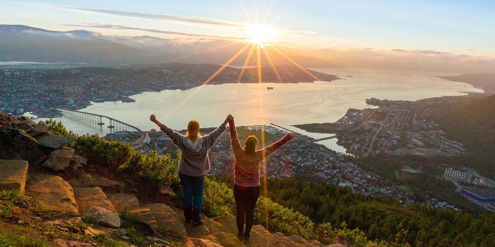 Two women are hiking up the Sherpa staircase to Mount Storsteinen in Tromsø, Northern Norway