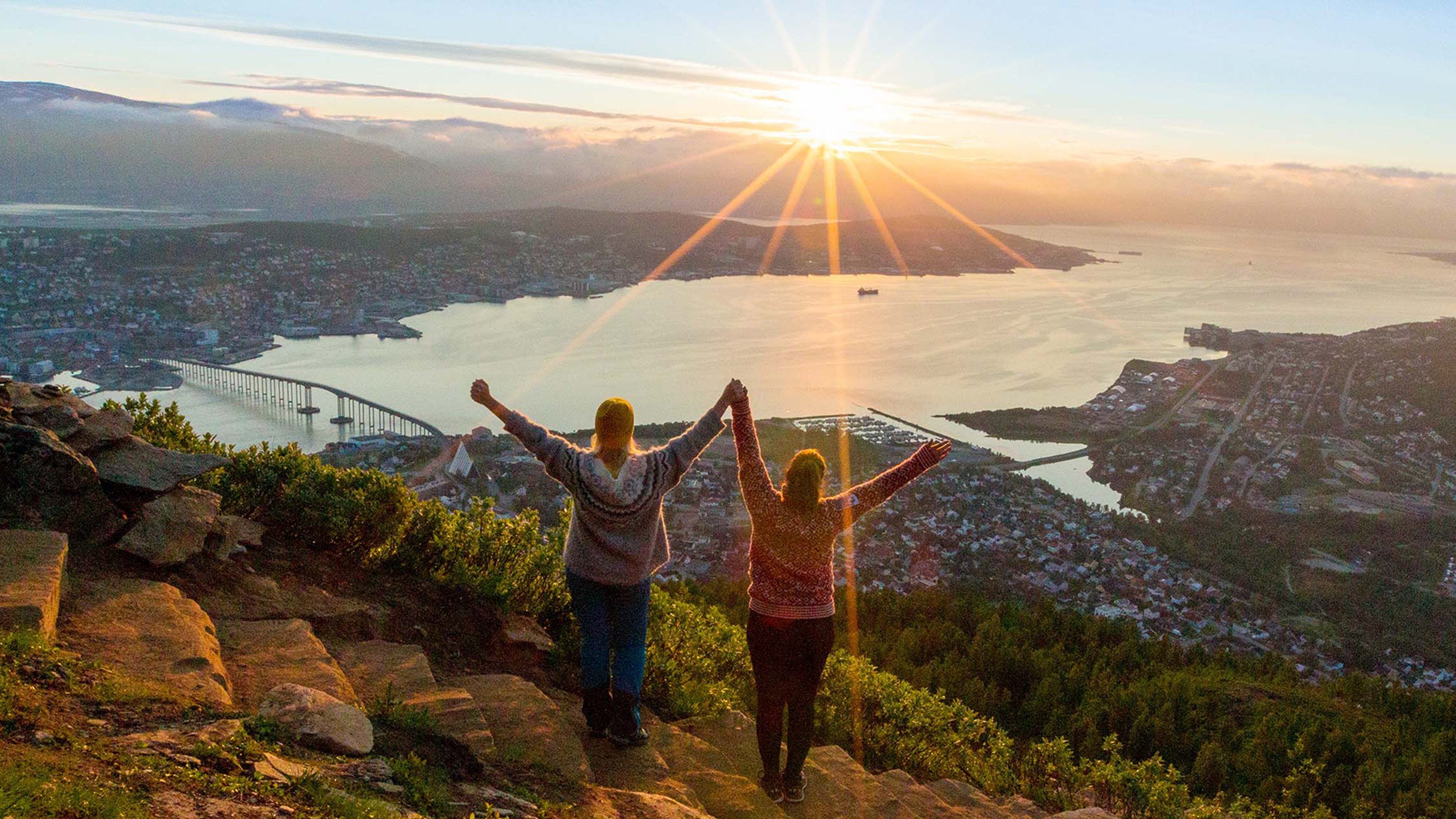 Two women are hiking up the Sherpa staircase to Mount Storsteinen in Tromsø, Northern Norway