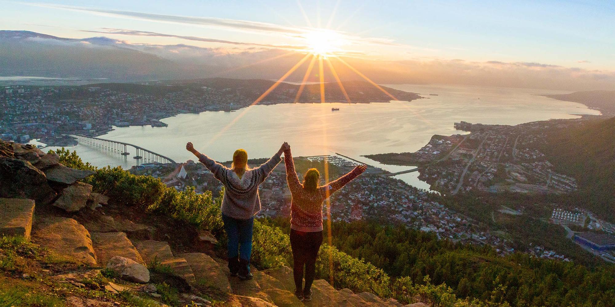 Two women are hiking up the Sherpa staircase to Mount Storsteinen in Tromsø, Northern Norway