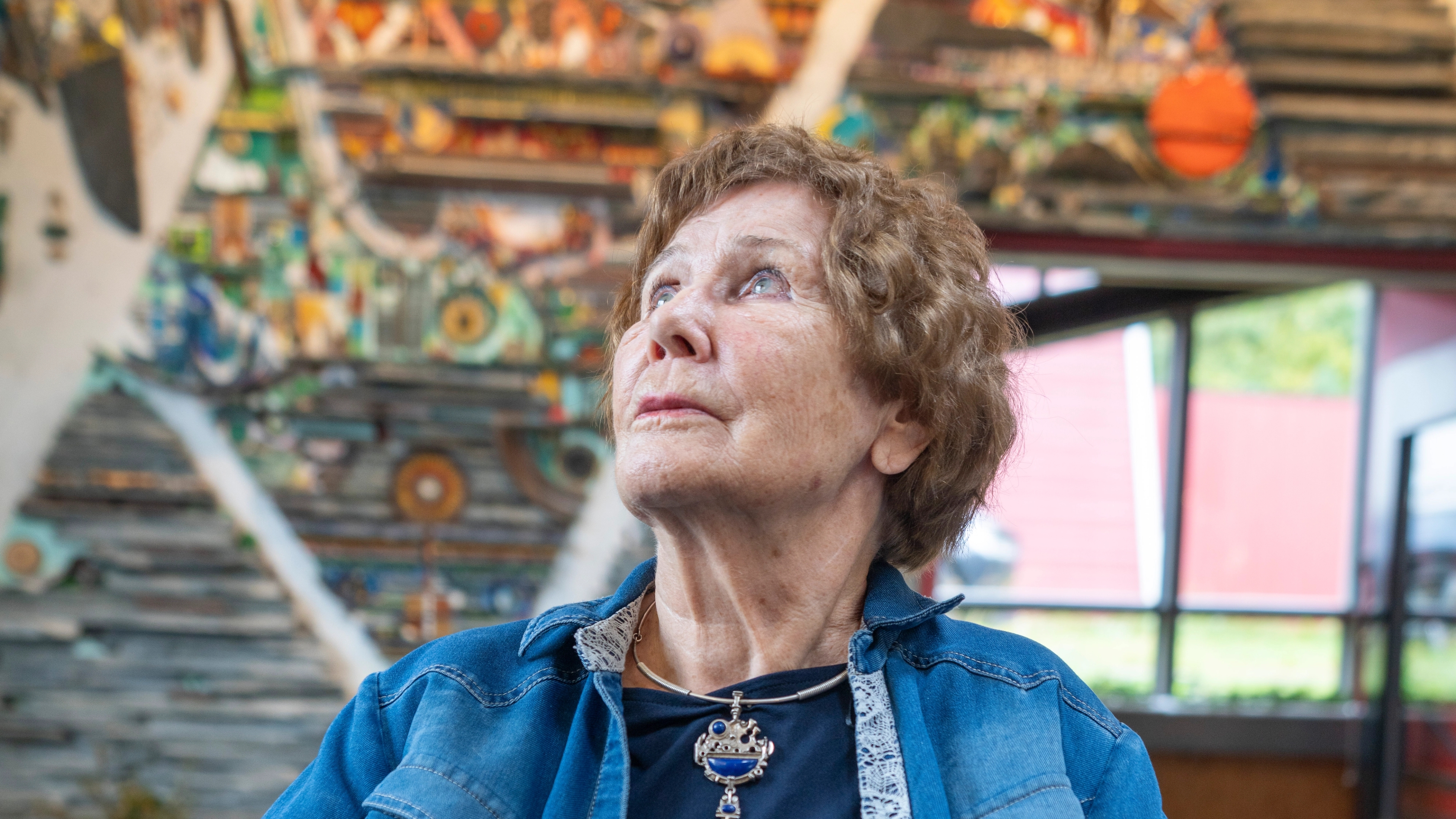 Regine Juhls in front of her mosaic at Juhls Silver Gallery