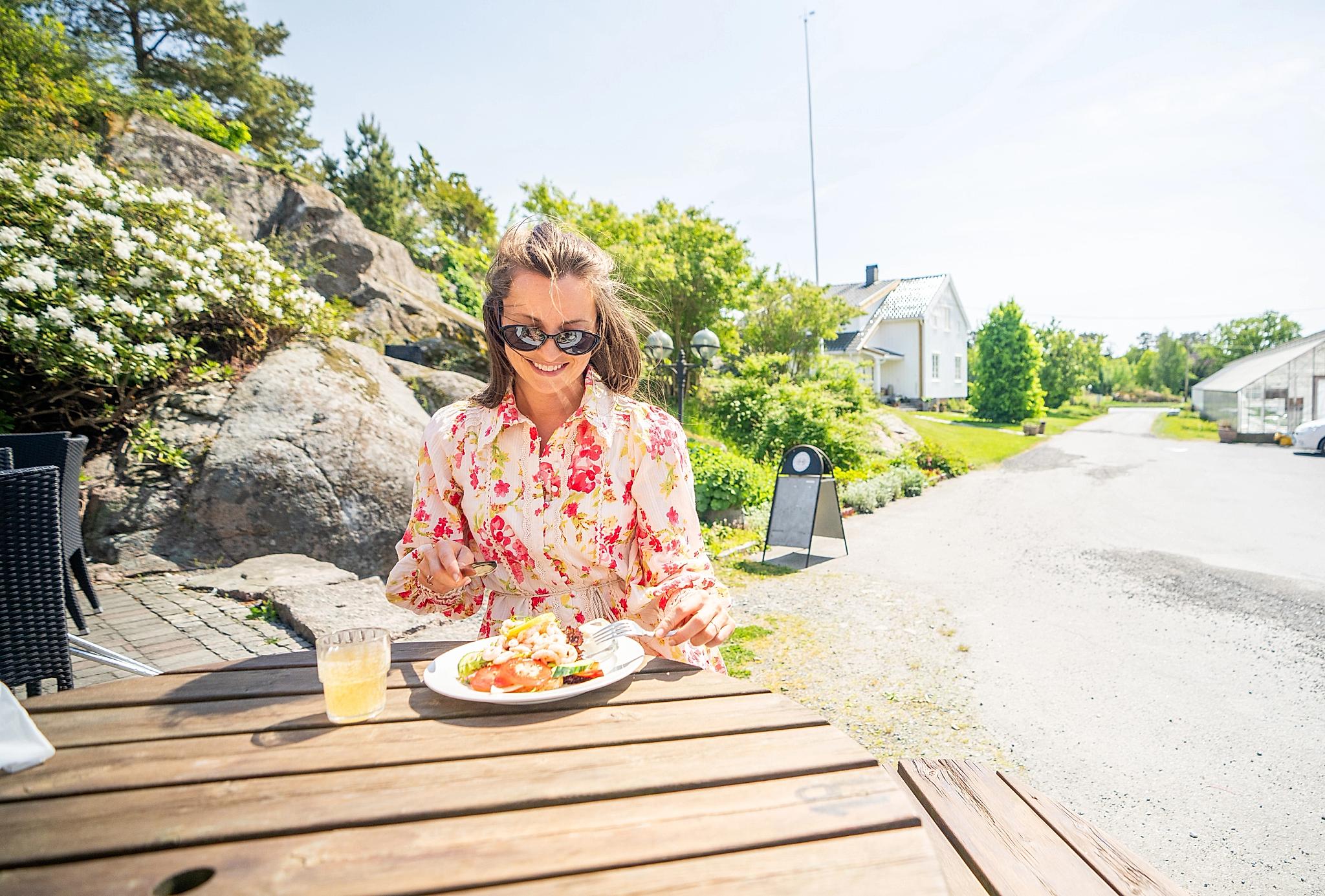 Girl enjoying a meal at Hesnes Gartneri, just outside Grimstad, Southern Norway