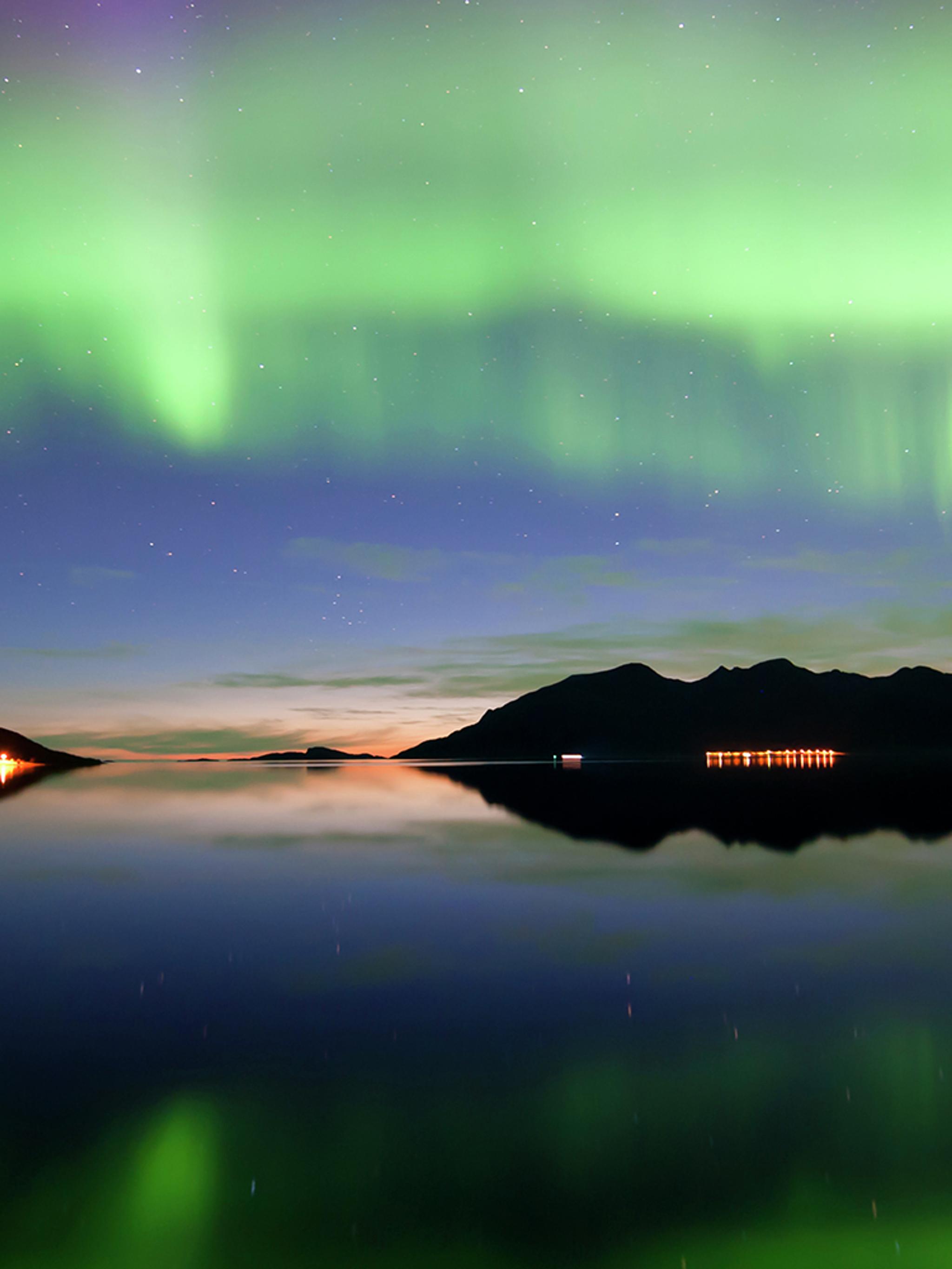 Northern lights over Grøtfjord in Kvaløya, Northern Norway