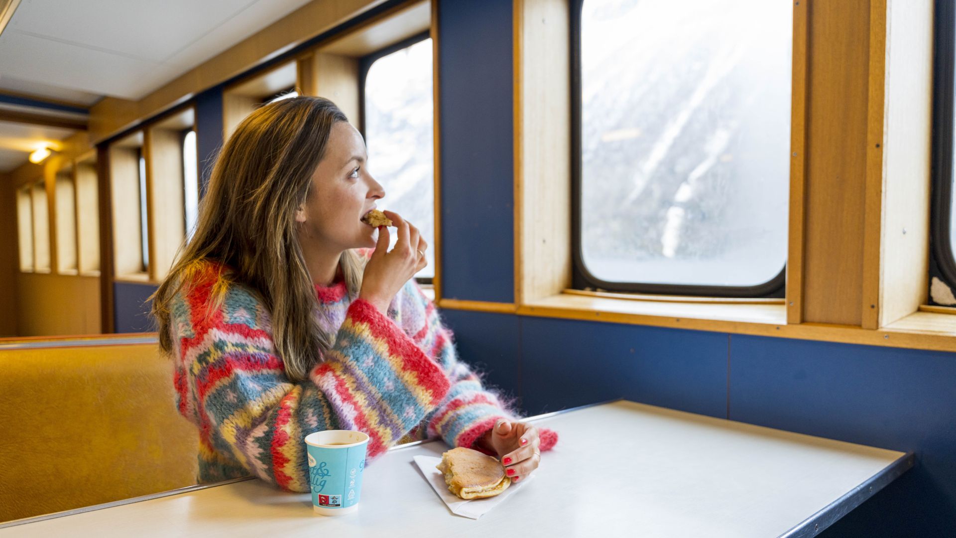 Woman eating svele on the Fram ferry between Geiranger and Hellesylt