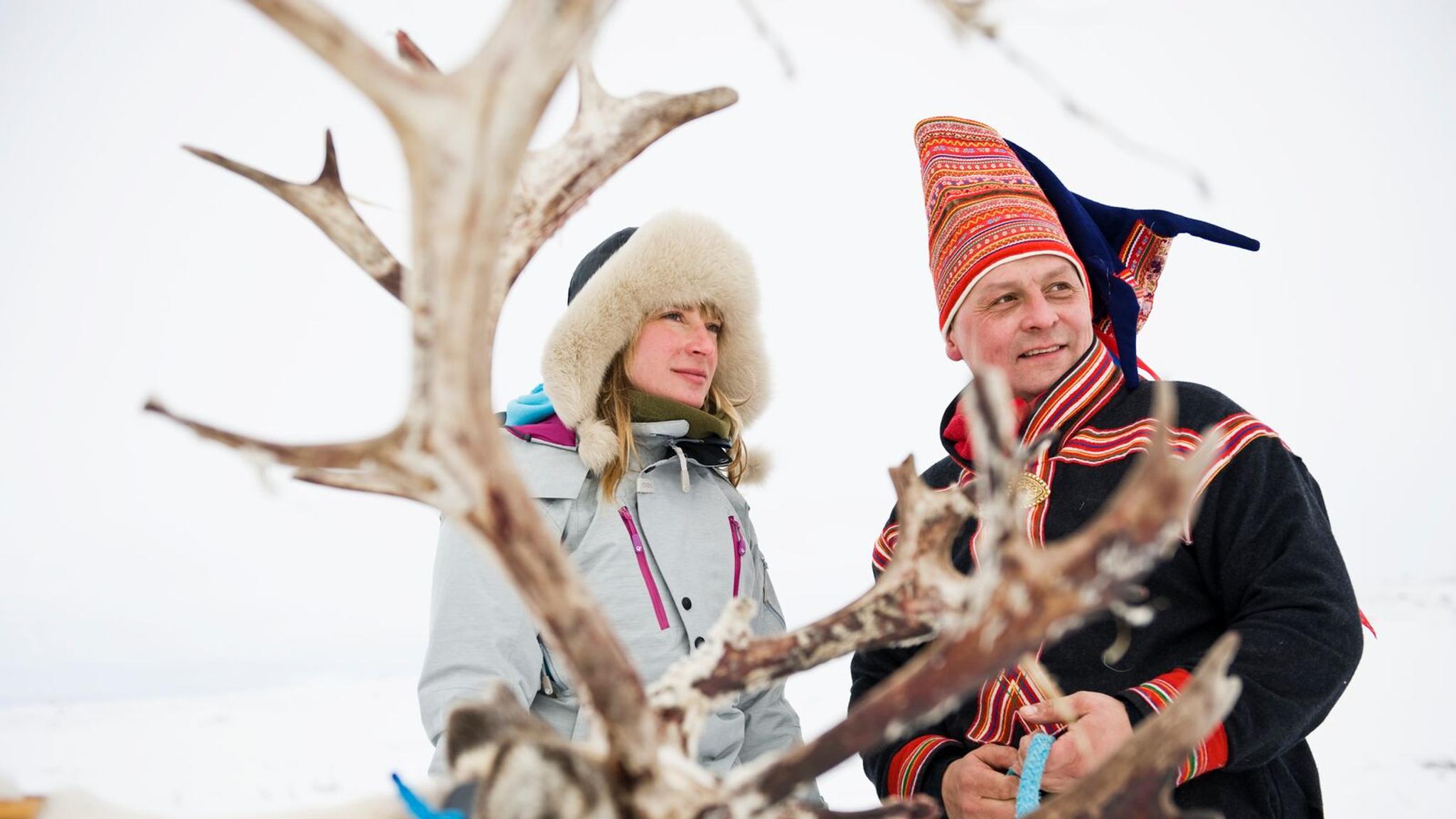 Woman and Sami man with reindeer in Finnmark