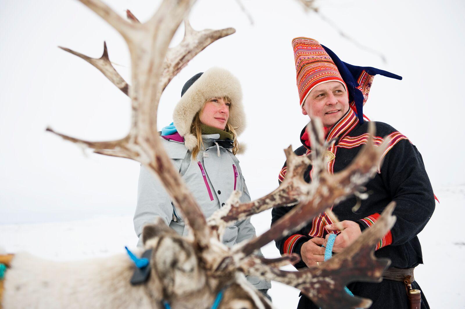 Woman and Sami man with reindeer in Finnmark