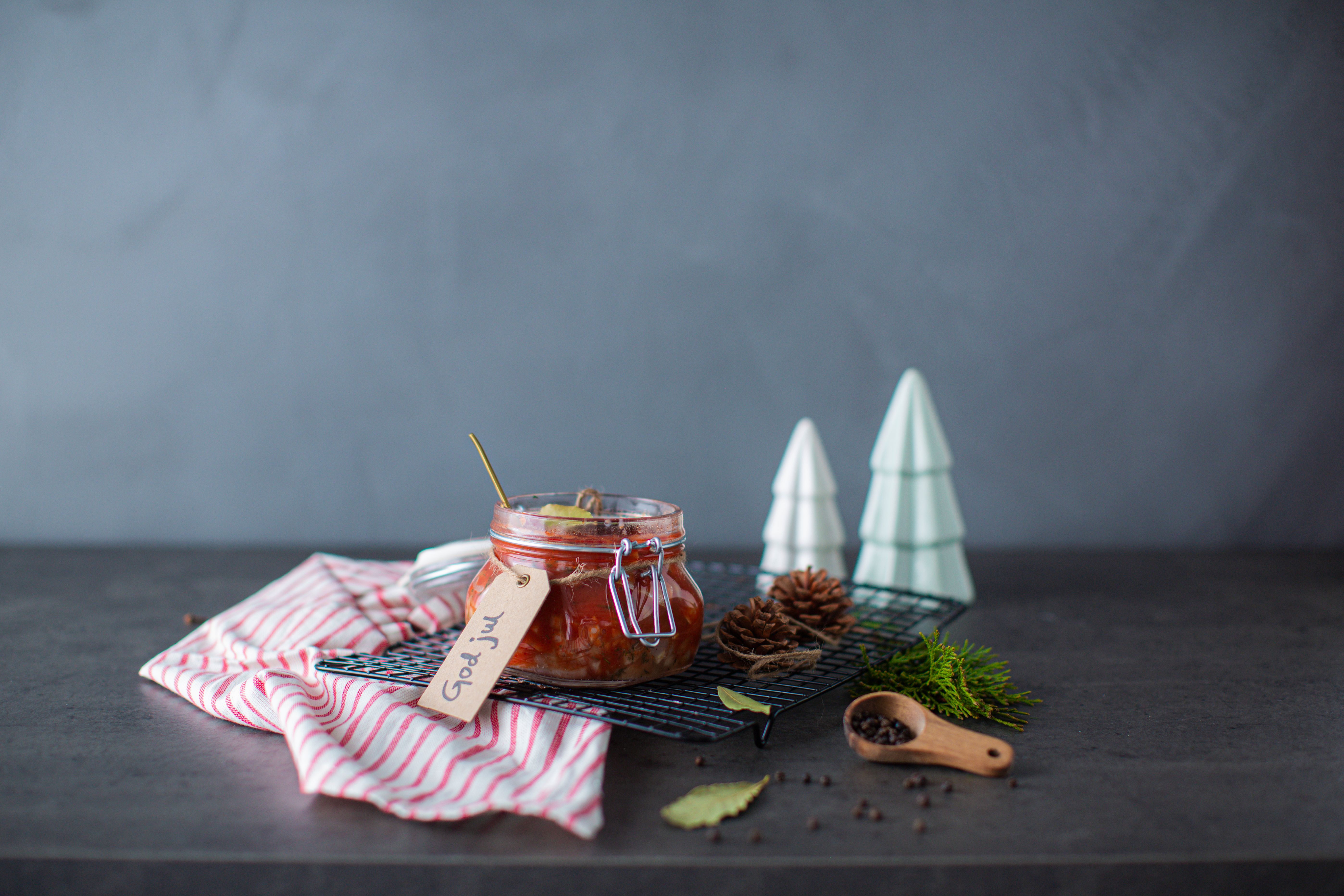 Traditional Norwegian pickled herring in a glass jar.