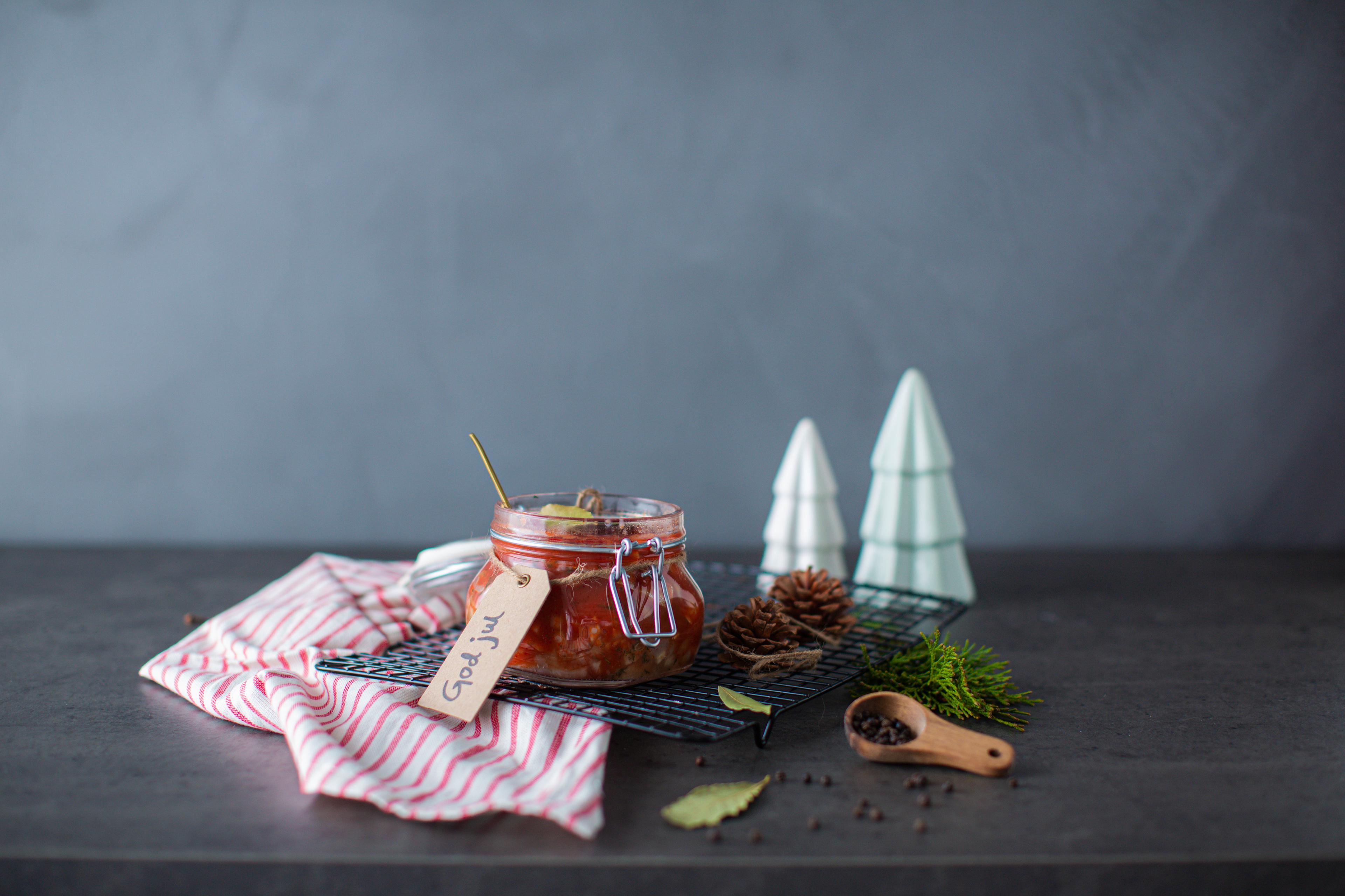 Traditional Norwegian pickled herring in a glass jar.