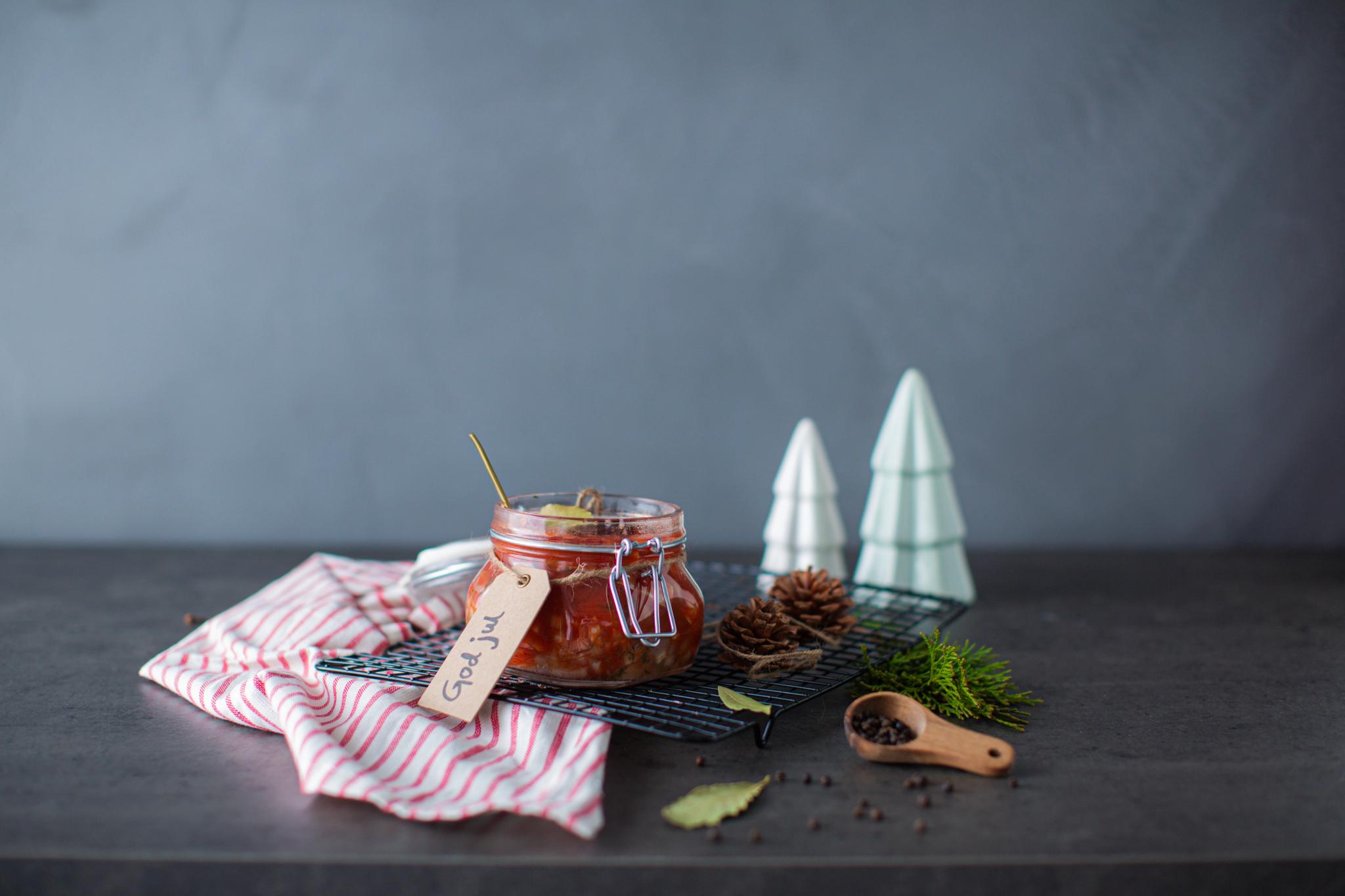 Traditional Norwegian pickled herring in a glass jar.