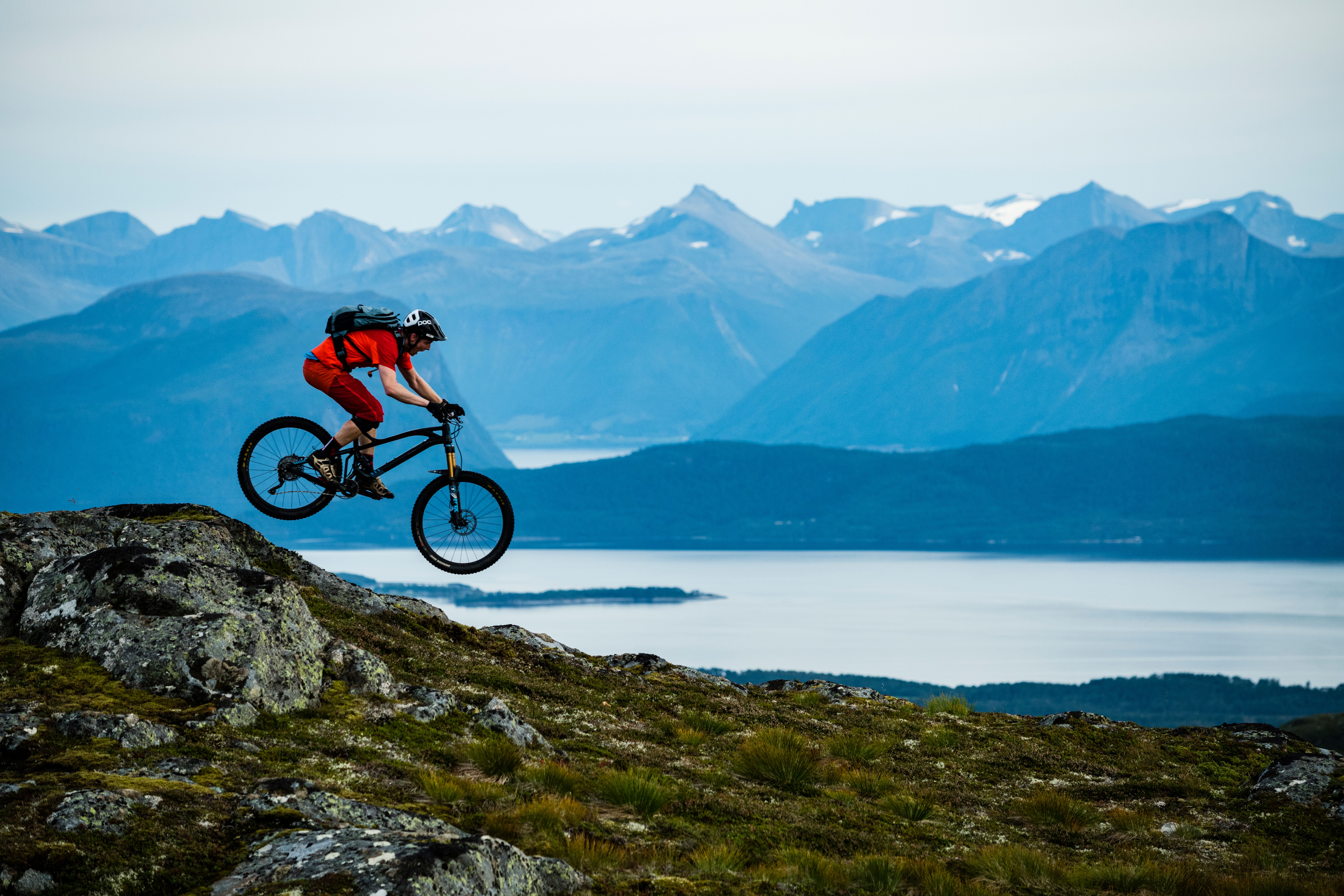 A person biking in Moldemarka in Molde with fjord and mountains in the background. Northwest, Fjord Norway.