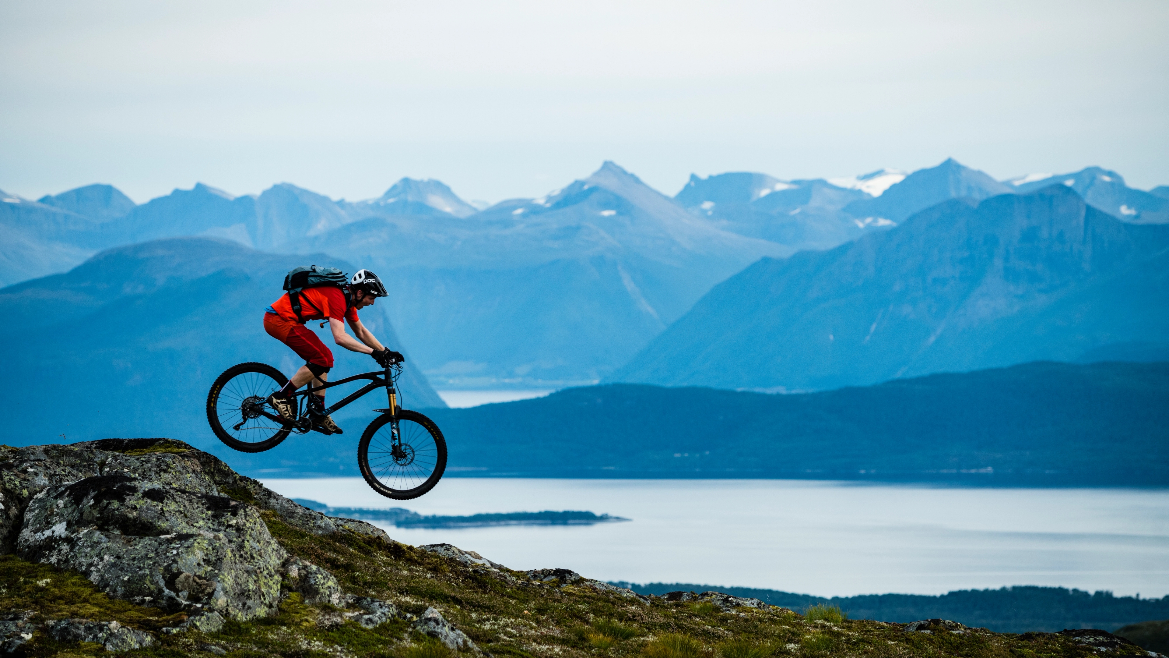 A person biking in Moldemarka in Molde with fjord and mountains in the background. Northwest, Fjord Norway.