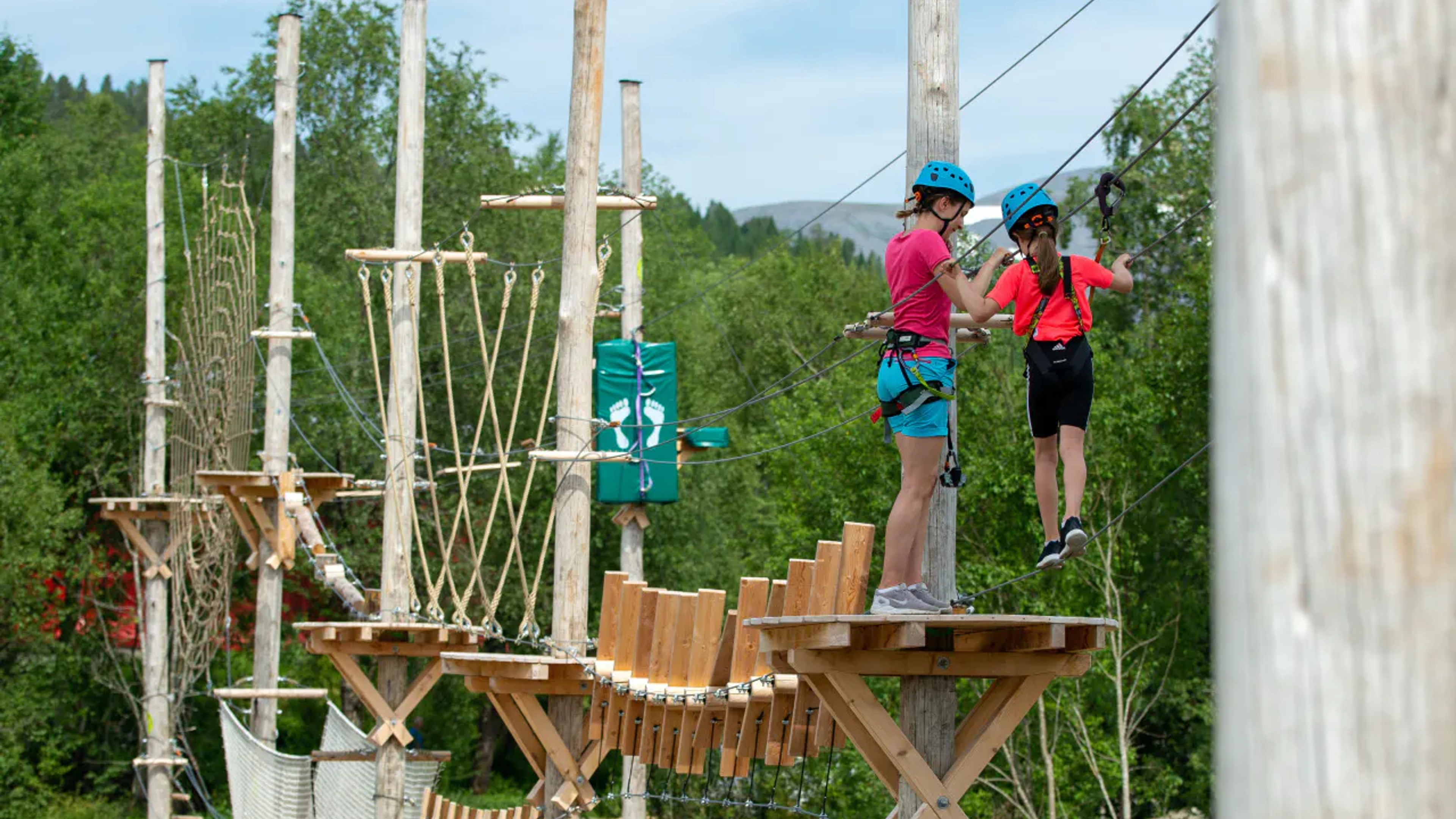 Two kids climbing in The Høyt og Lavt Molde climbing park