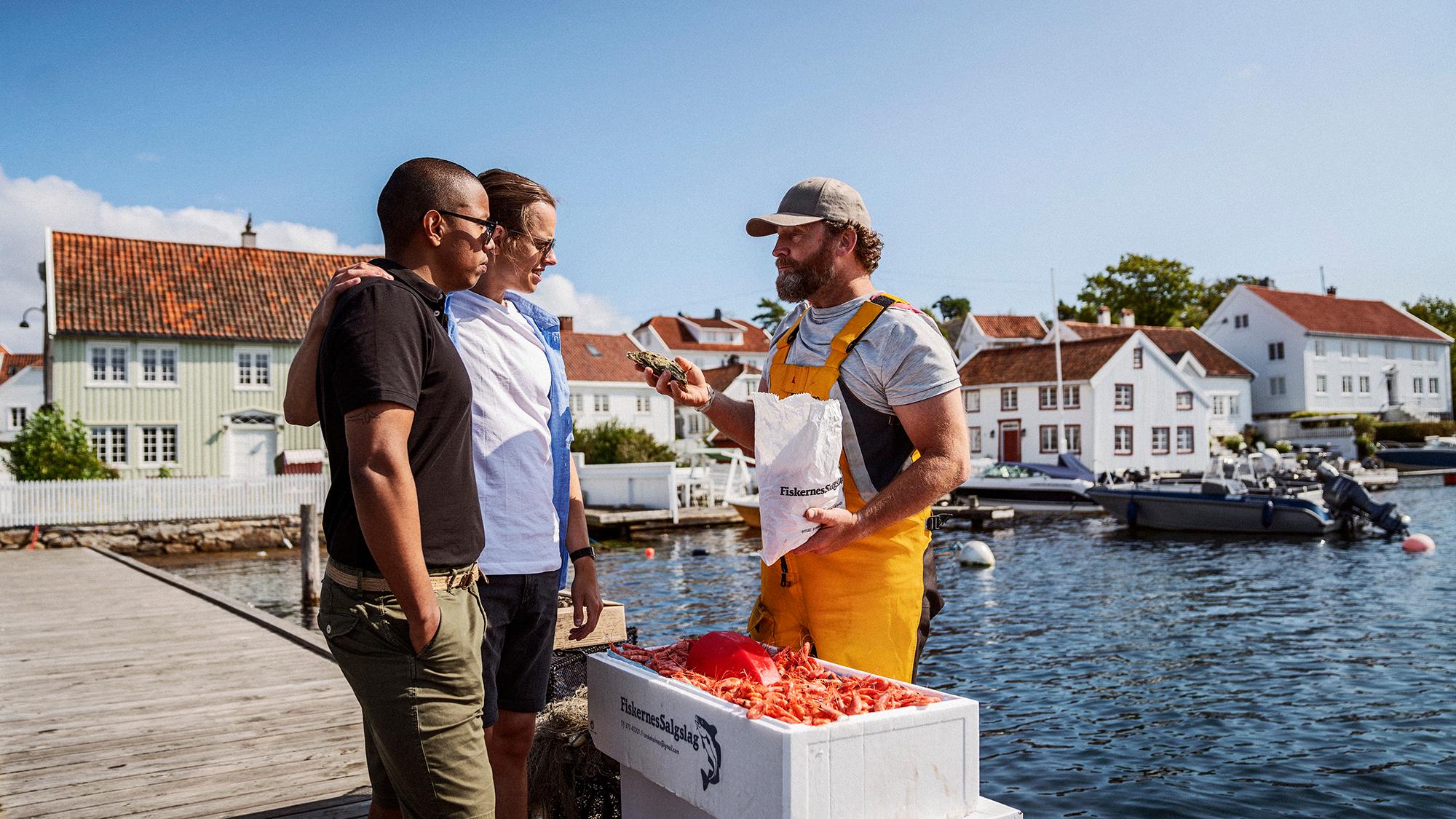 Friends buying fresh shrimps from local fisherman in Southern Norway