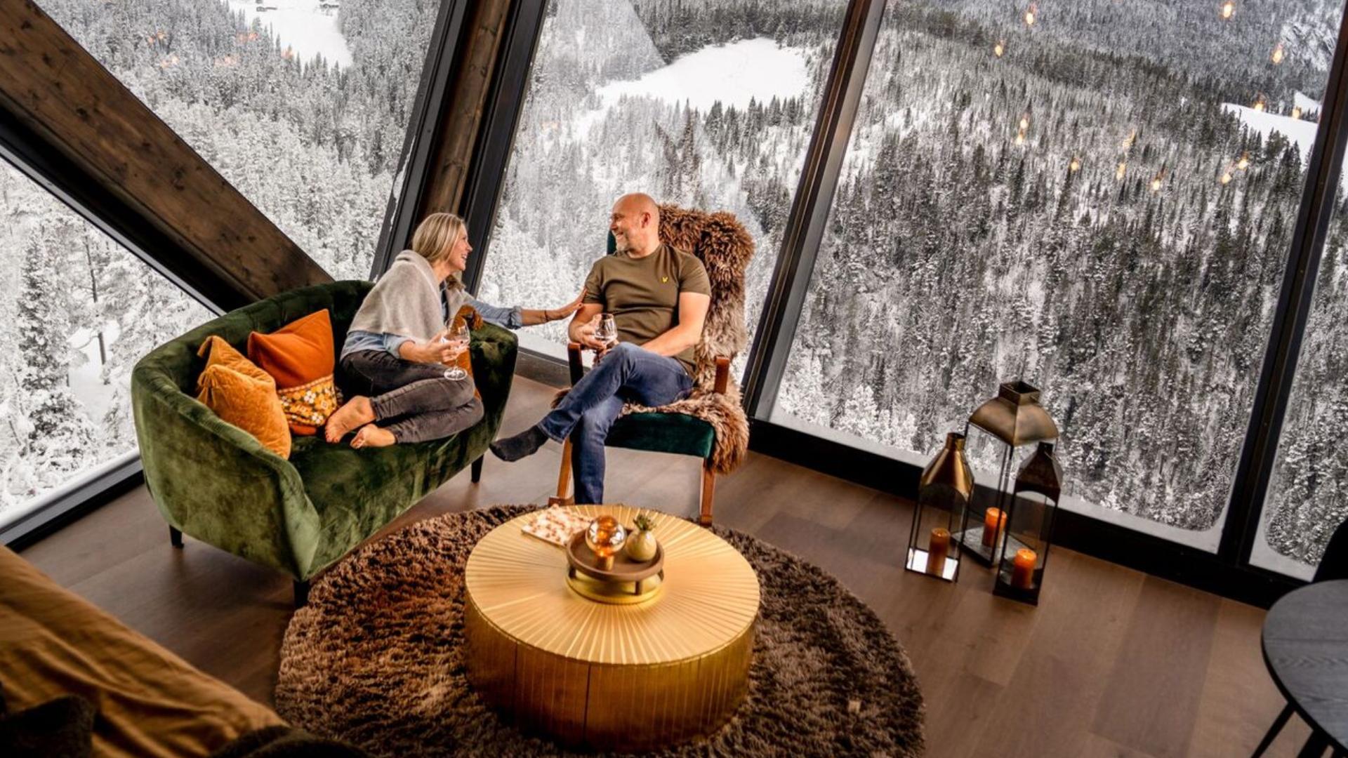 Two people sitting in a sofa in Eagle Nest Eco Lodge in Eastern Norway