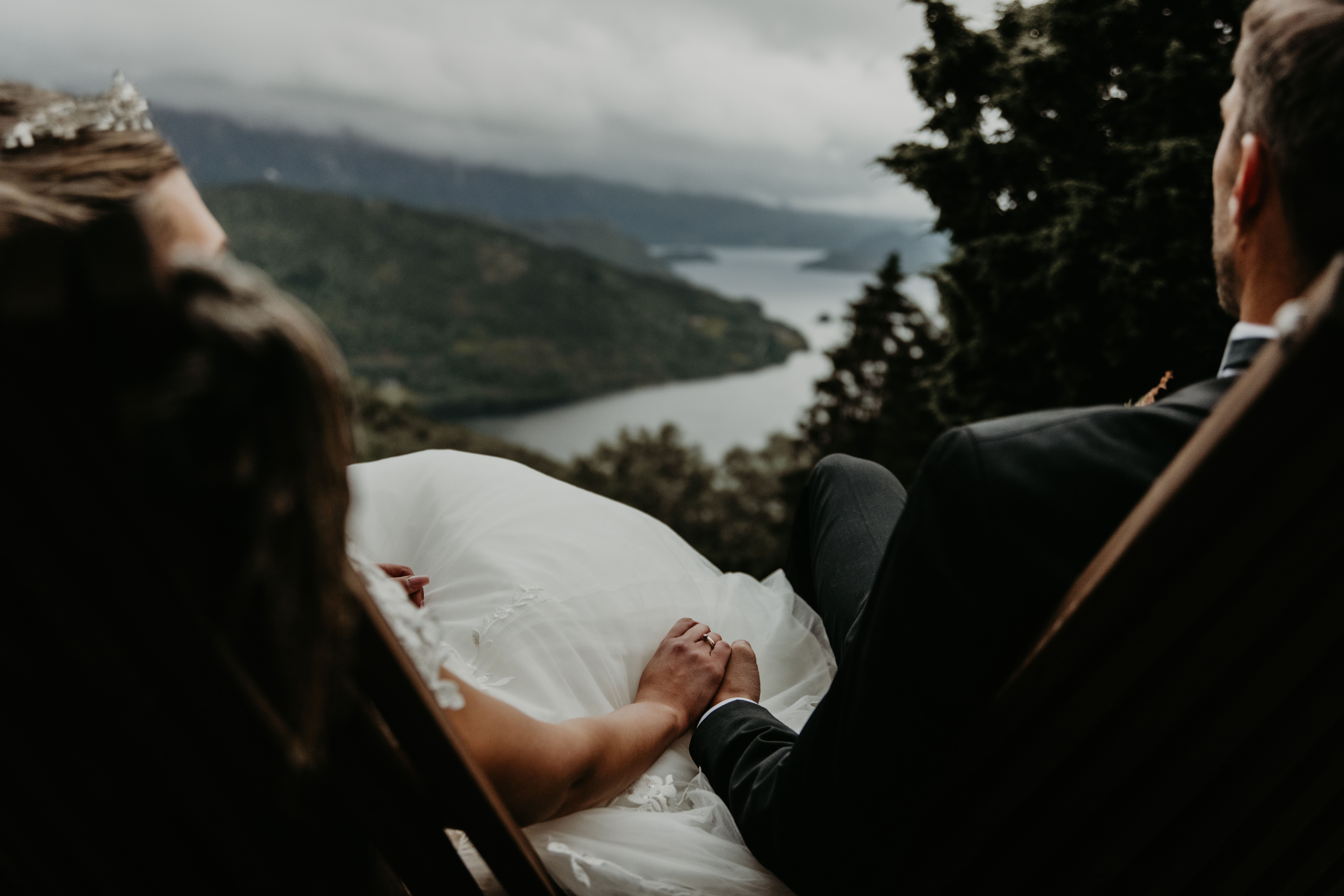 Married couple holding hands with a view