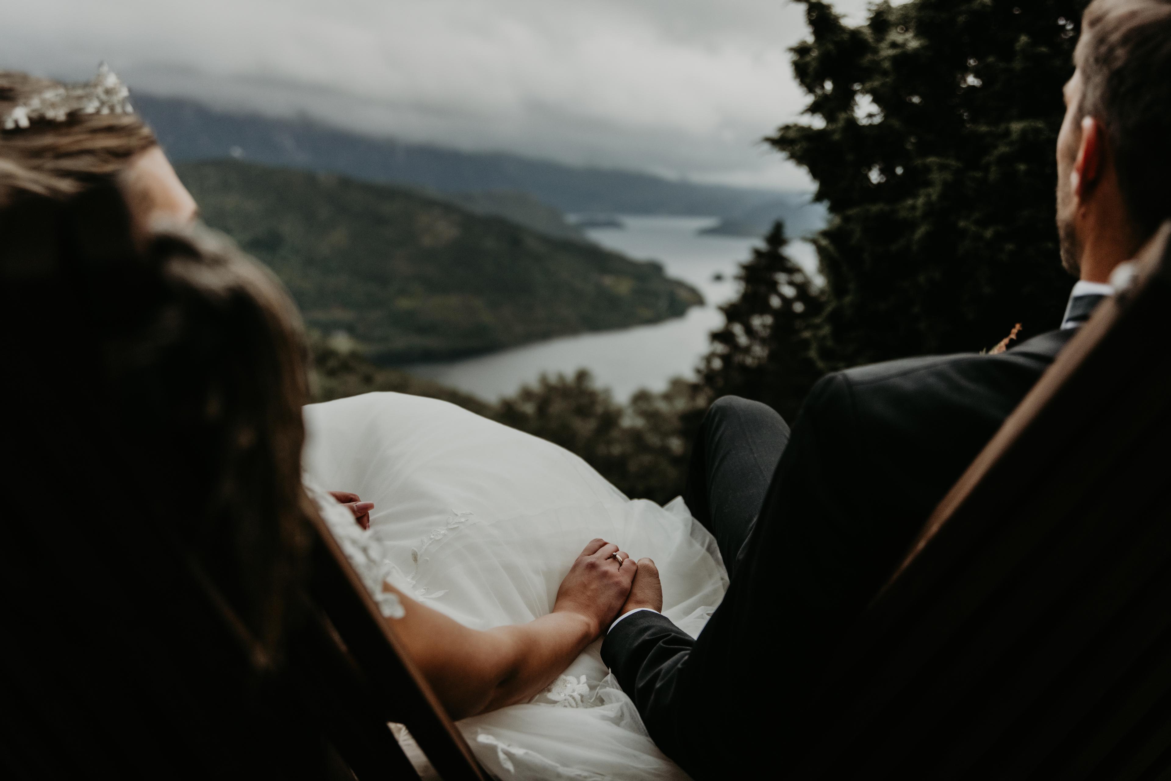 Married couple holding hands with a view