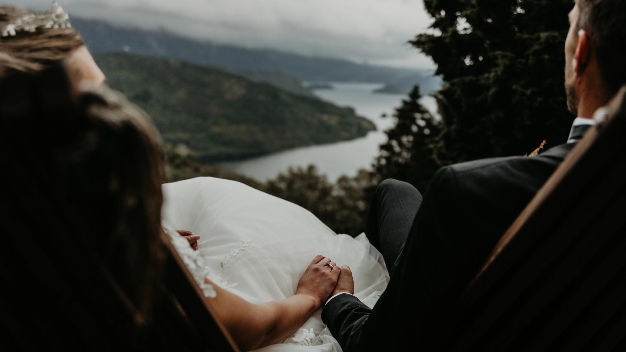 Married couple holding hands with a view