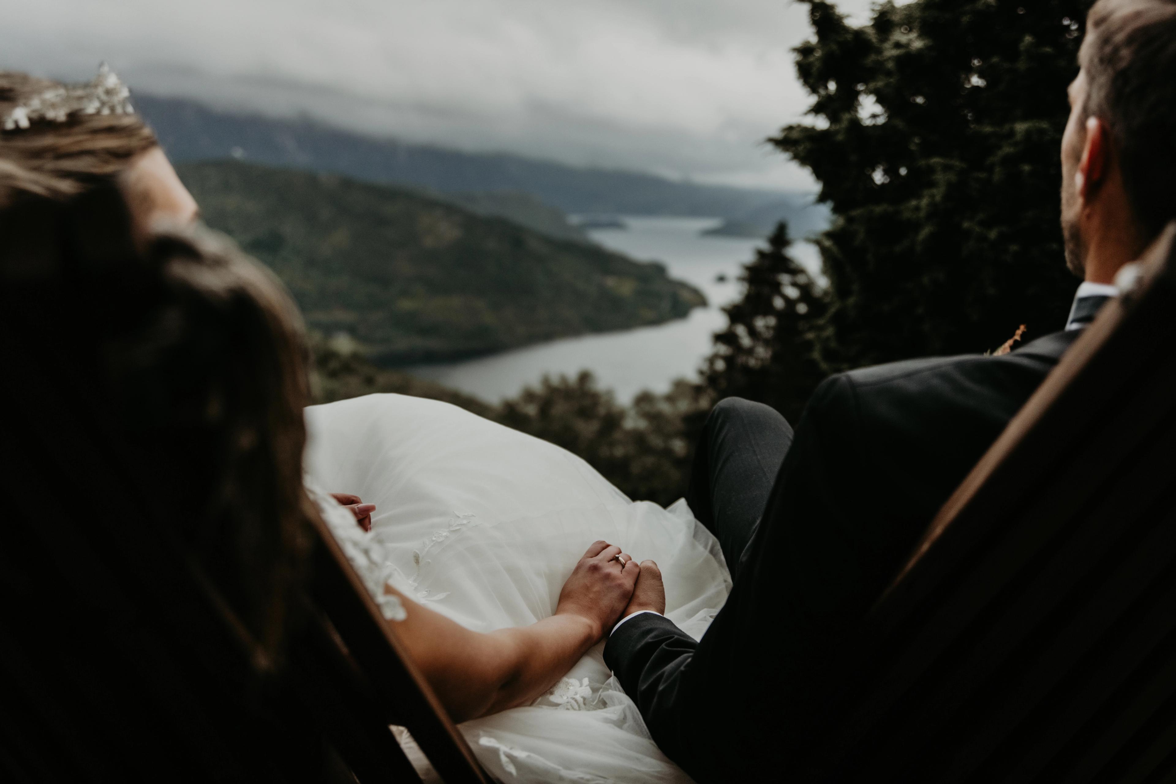 Married couple holding hands with a view