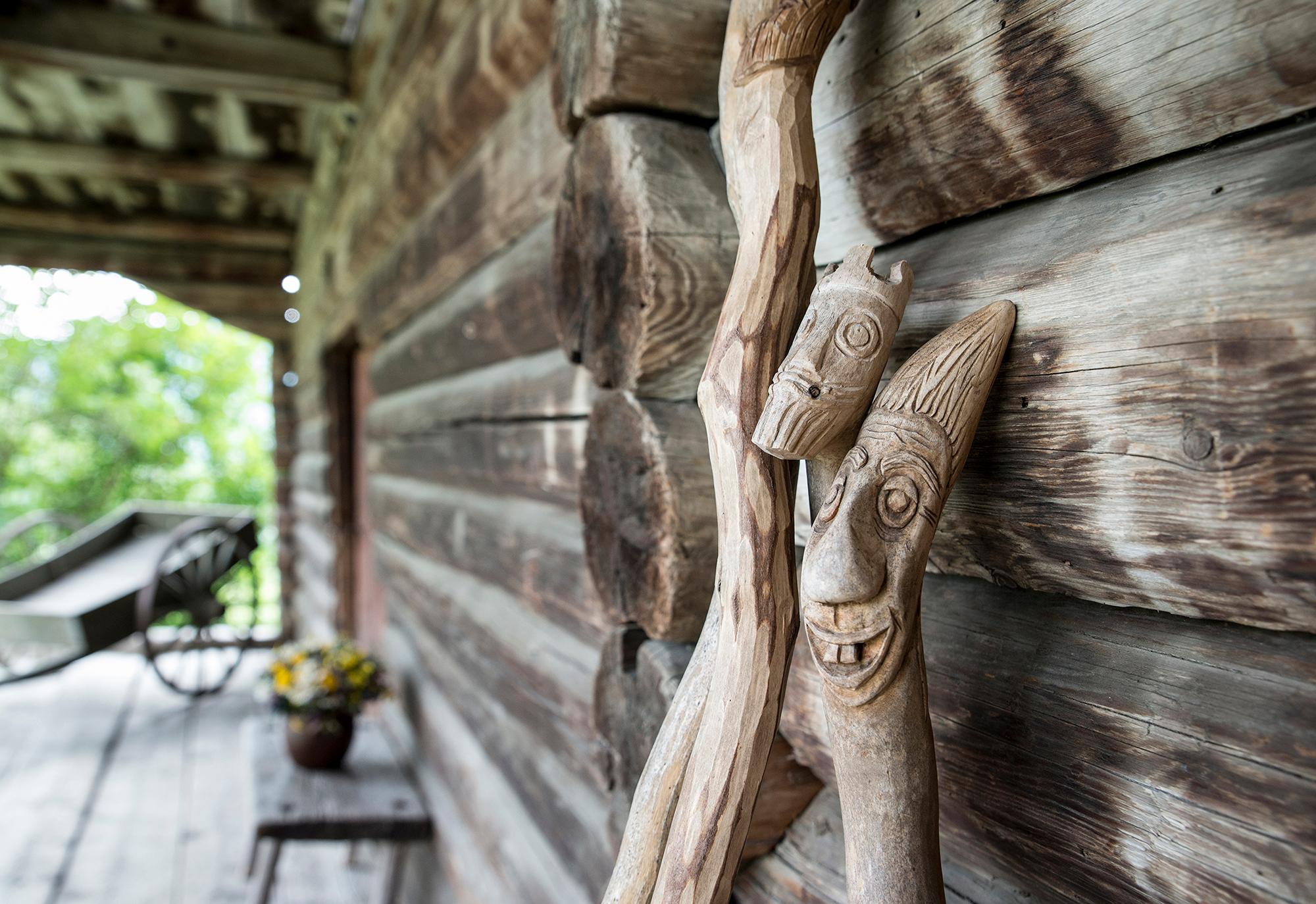 Wooden sticks with troll faces carved into them at Sygard Grytting, Gudbrandsdalen, Eastern Norway