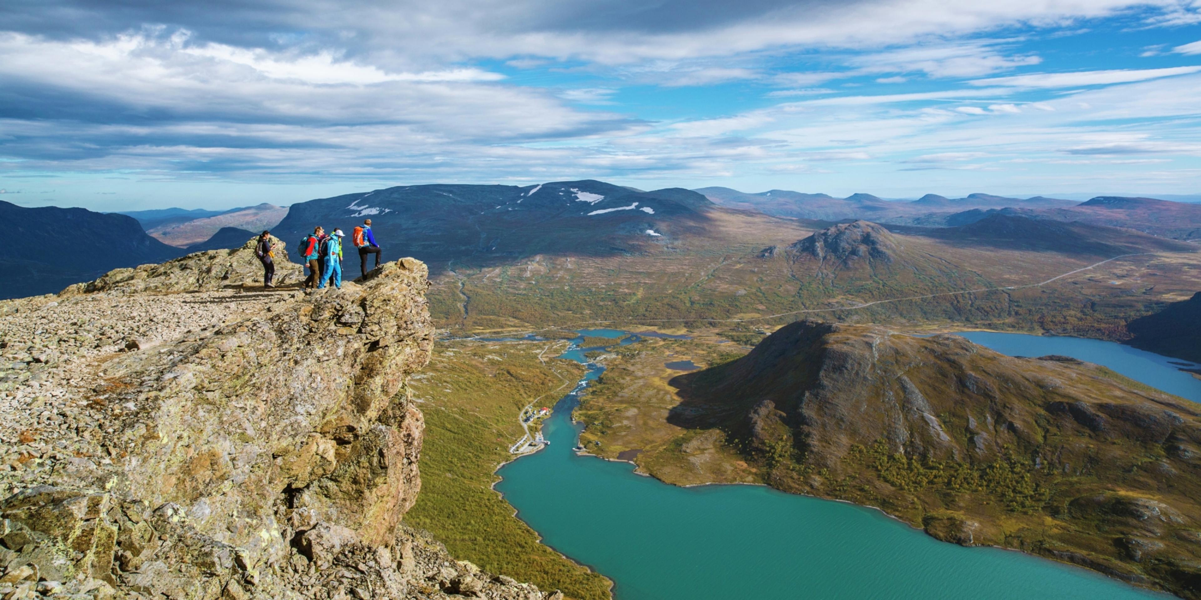 A group of people standing on the top of the Besseggen ridge in Jotunheimen