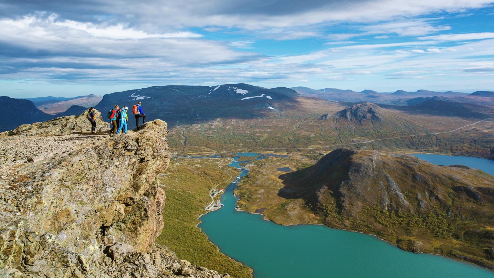 A group of people standing on the top of the Besseggen ridge in Jotunheimen